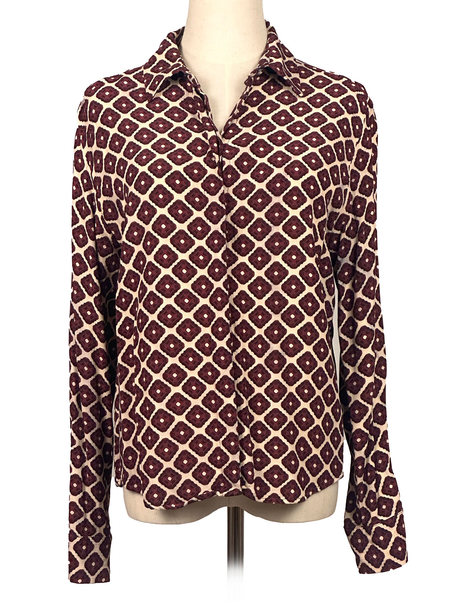 Patterned shirt on a mannequin against a white background