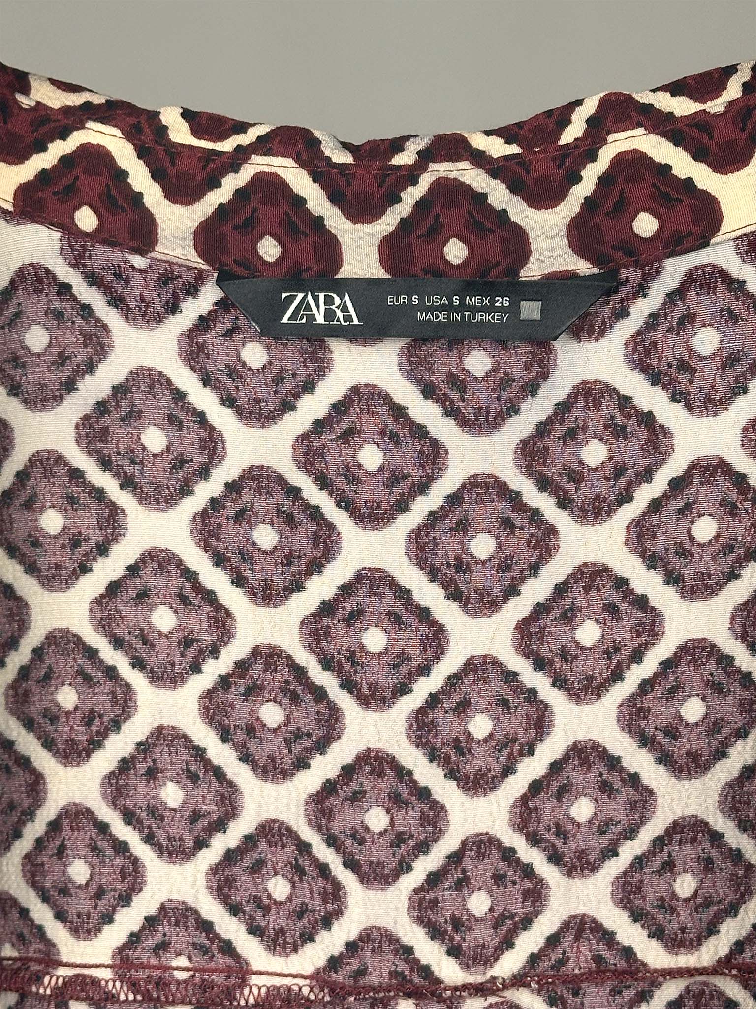 Patterned fabric with Zara label on a gray background