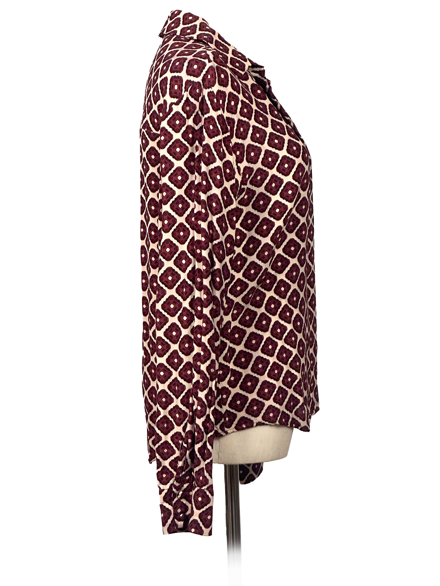 Patterned shirt on a mannequin against a white background