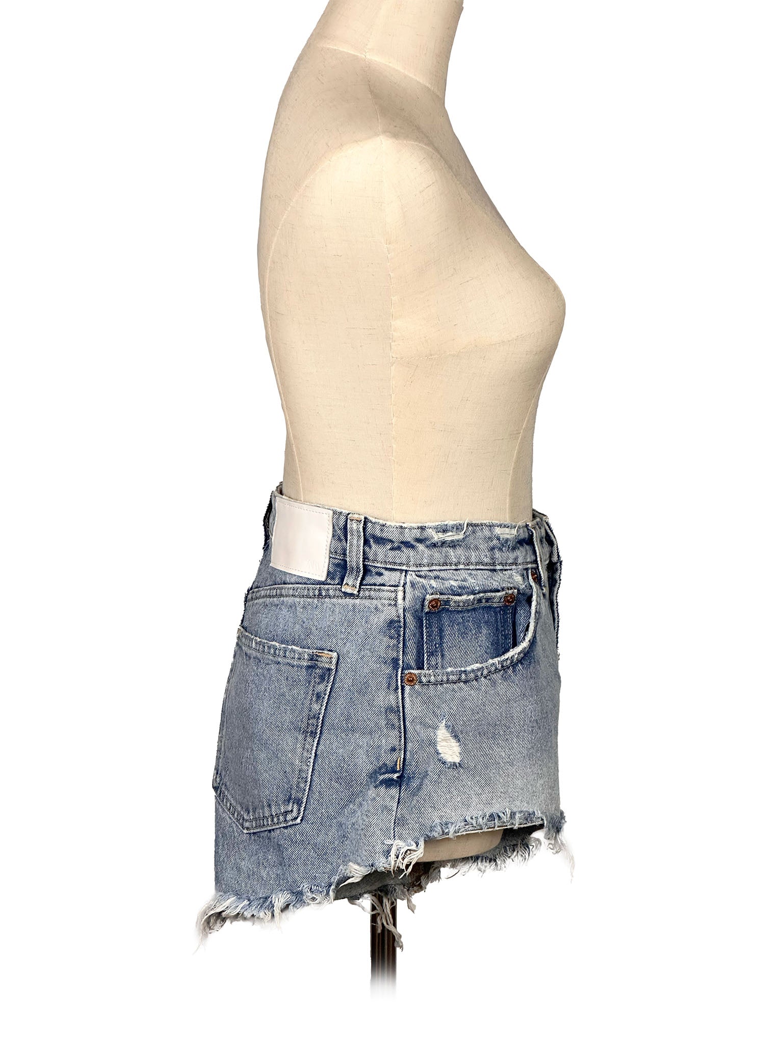 Denim shorts on a mannequin against a white background