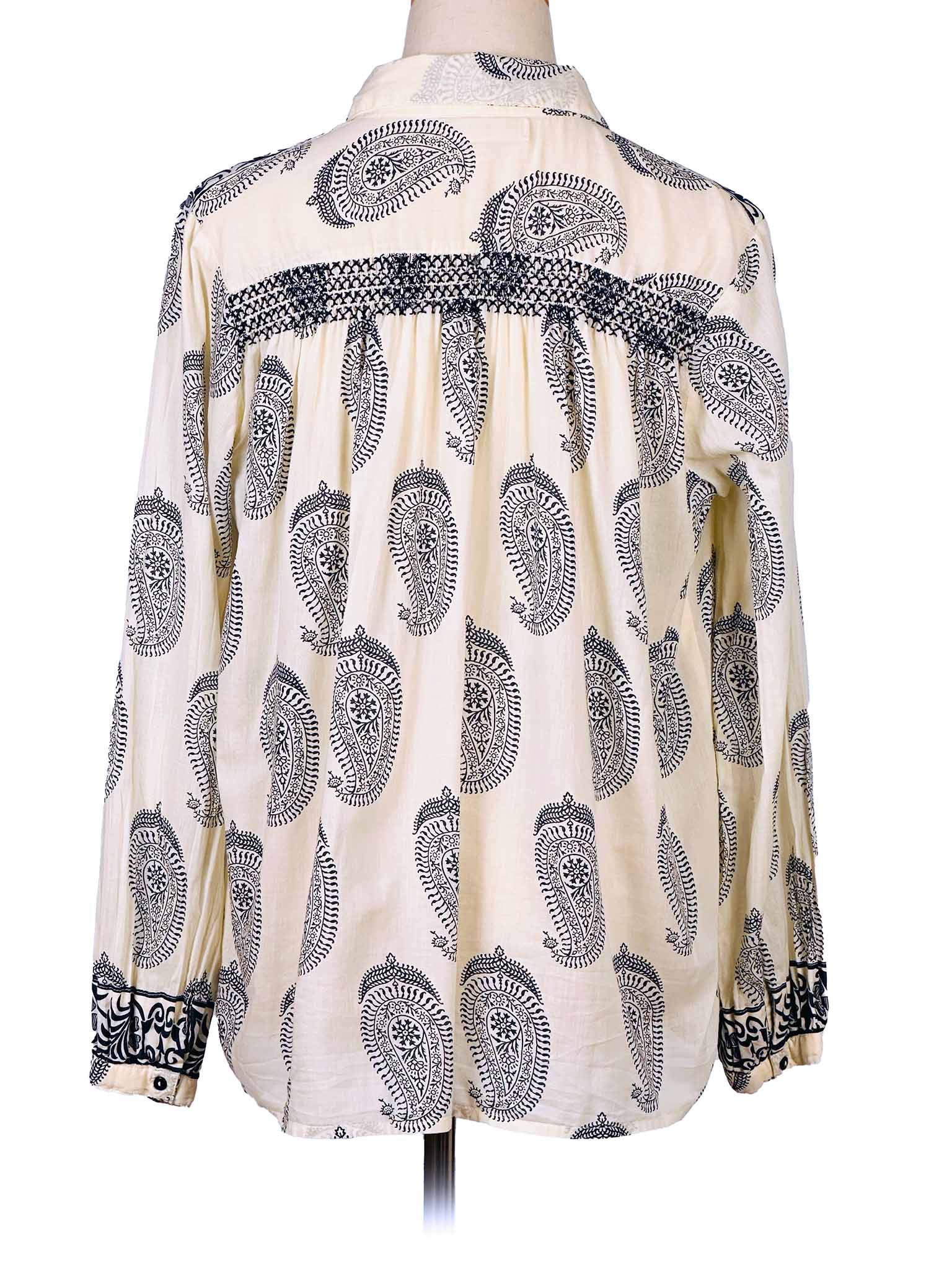 White shirt with dark blue paisley pattern on a mannequin against a white background