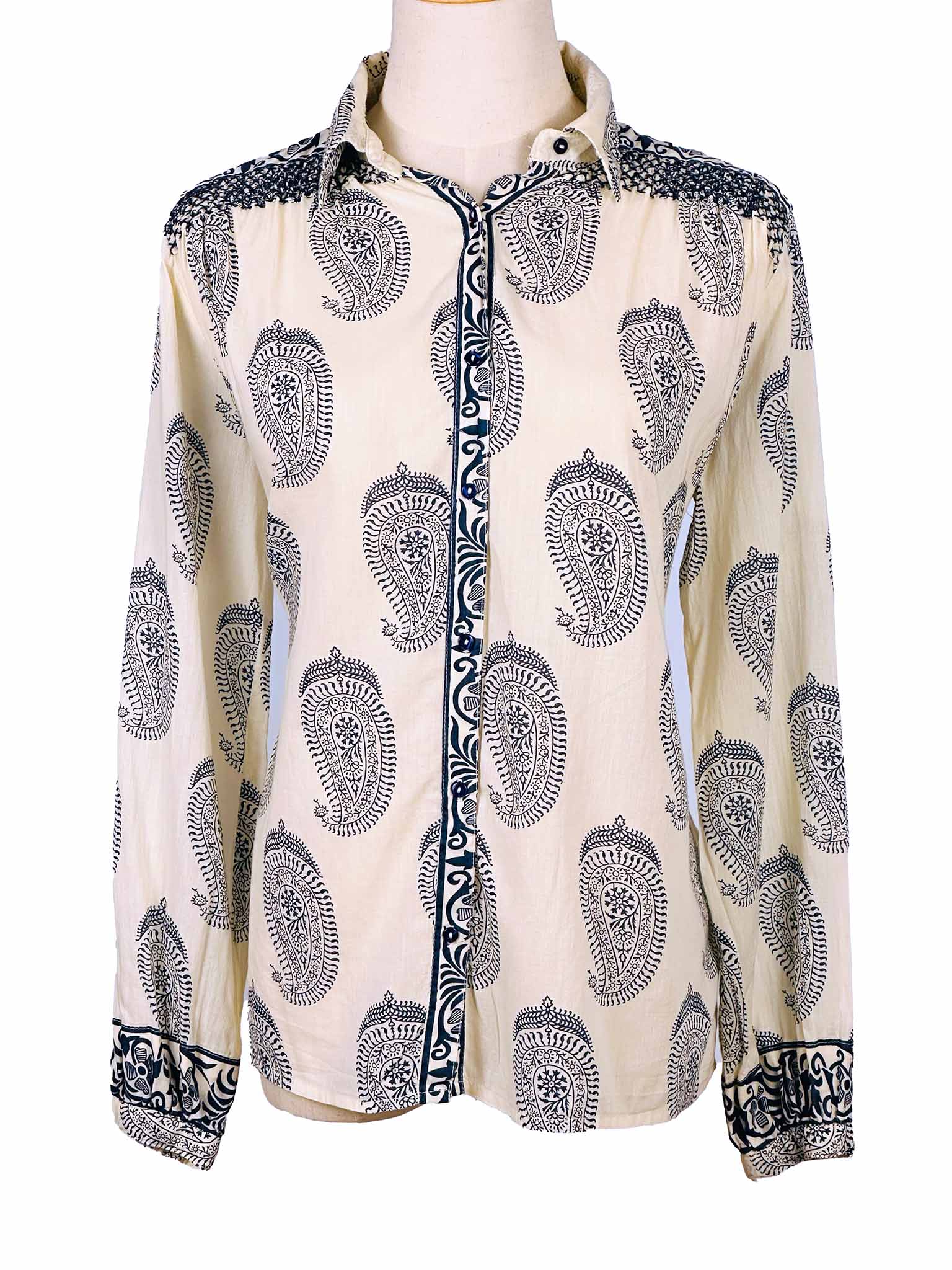 White shirt with dark blue paisley pattern on a mannequin against a white background