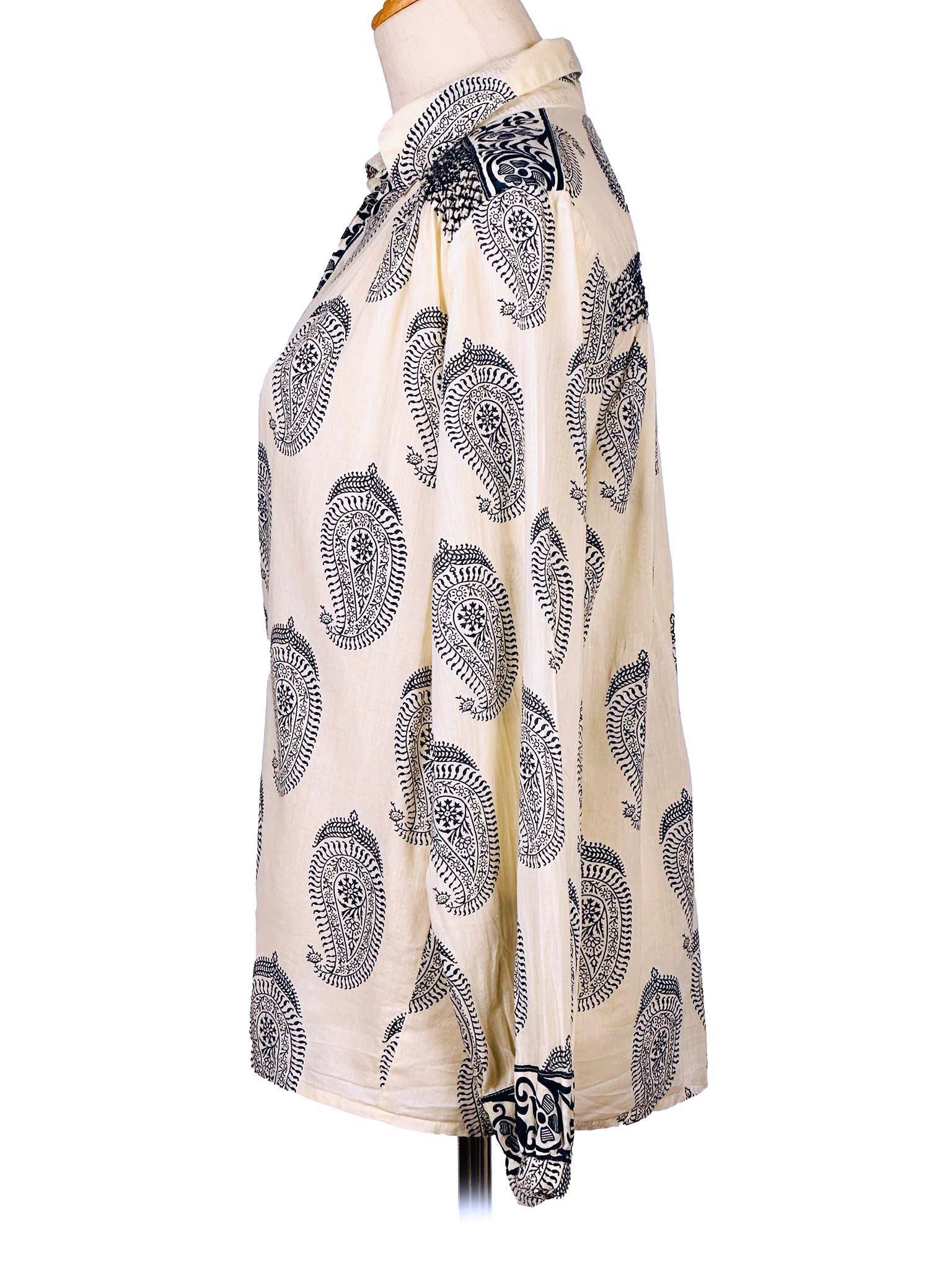 White shirt with dark blue paisley pattern on a mannequin against a white background