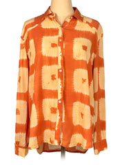 Orange and beige tie-dye shirt on a mannequin against a white background
