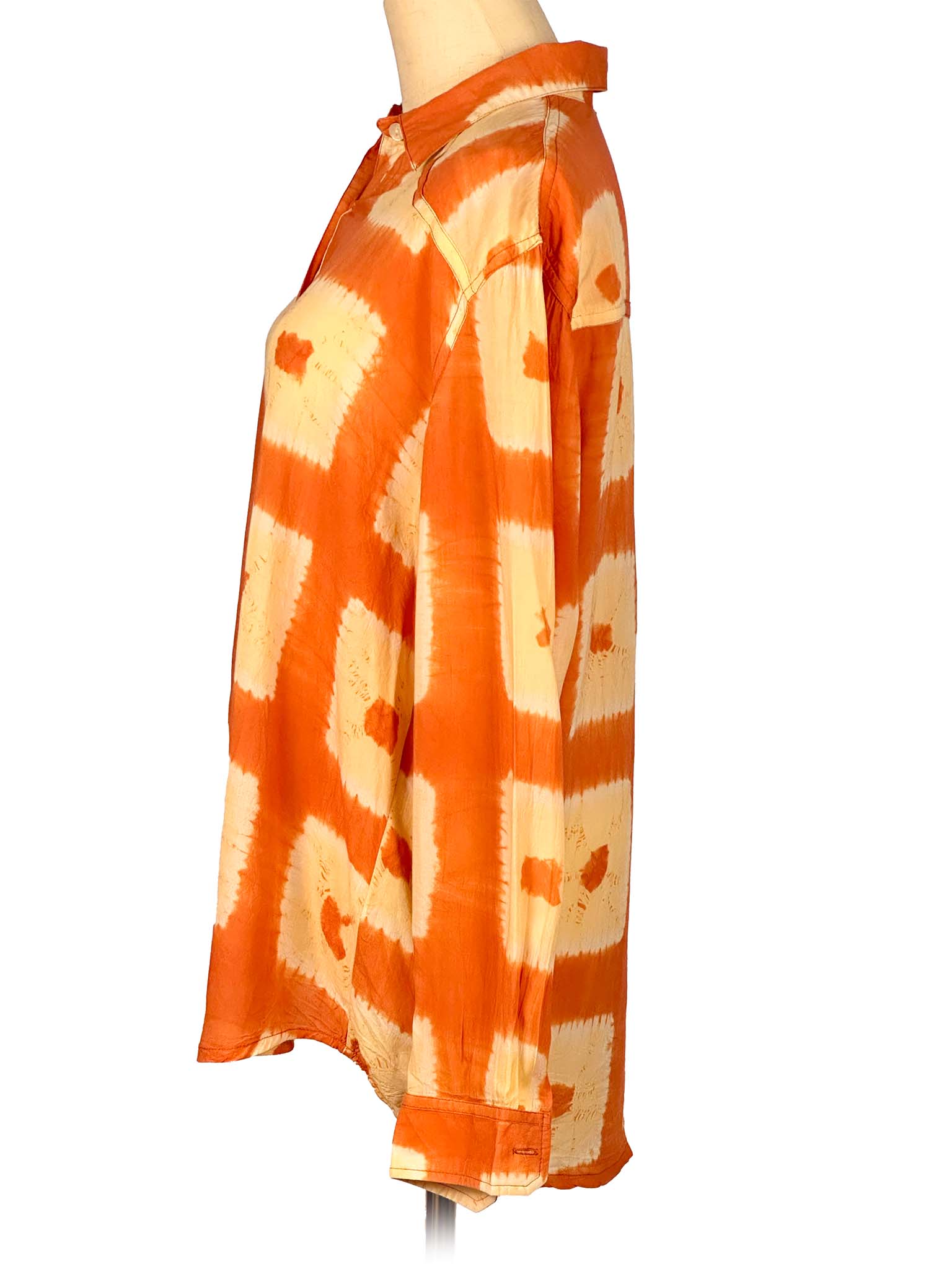 Orange and beige tie-dye skirt on a mannequin against a white background