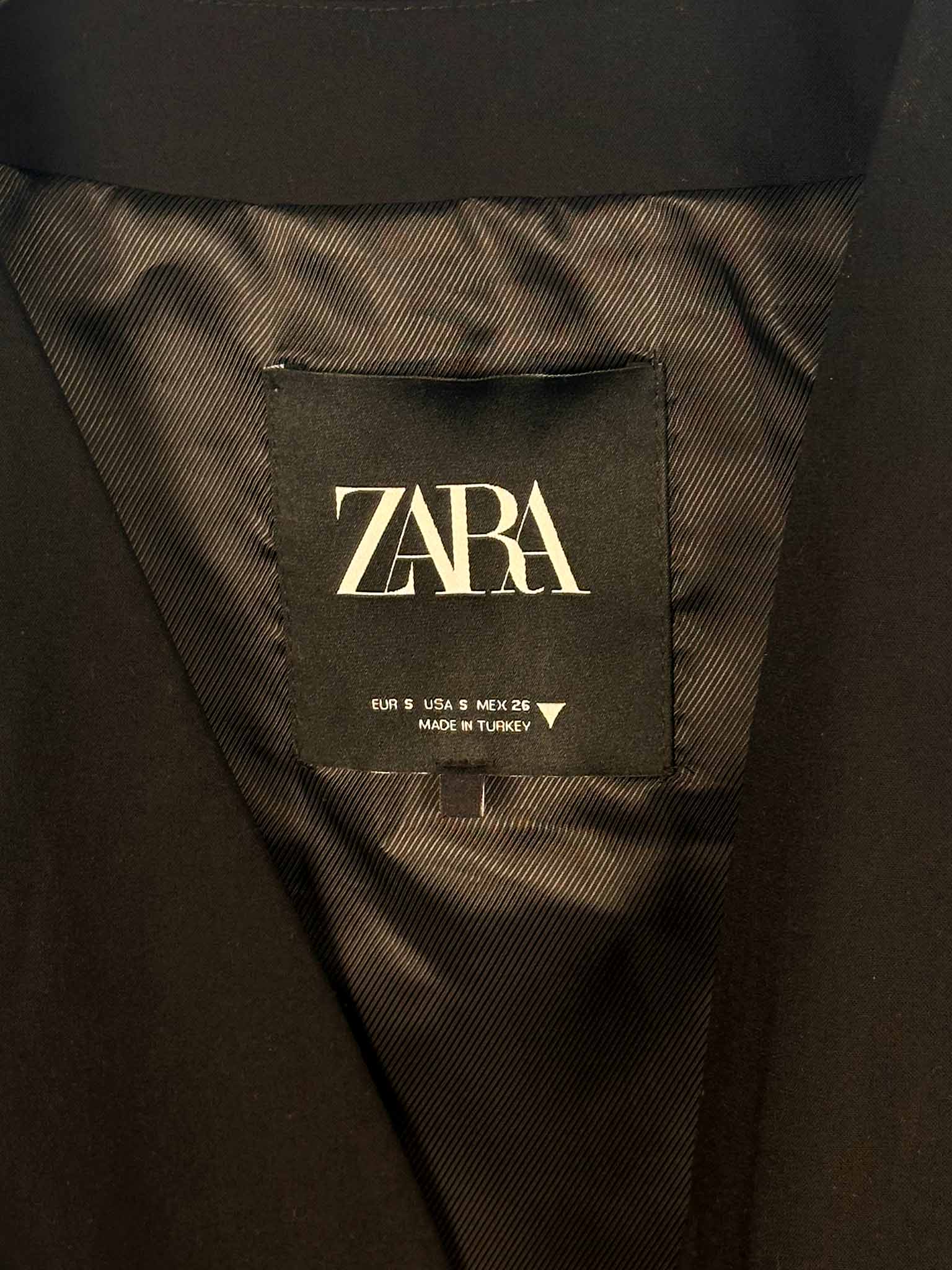 Zara label on a dark fabric background
