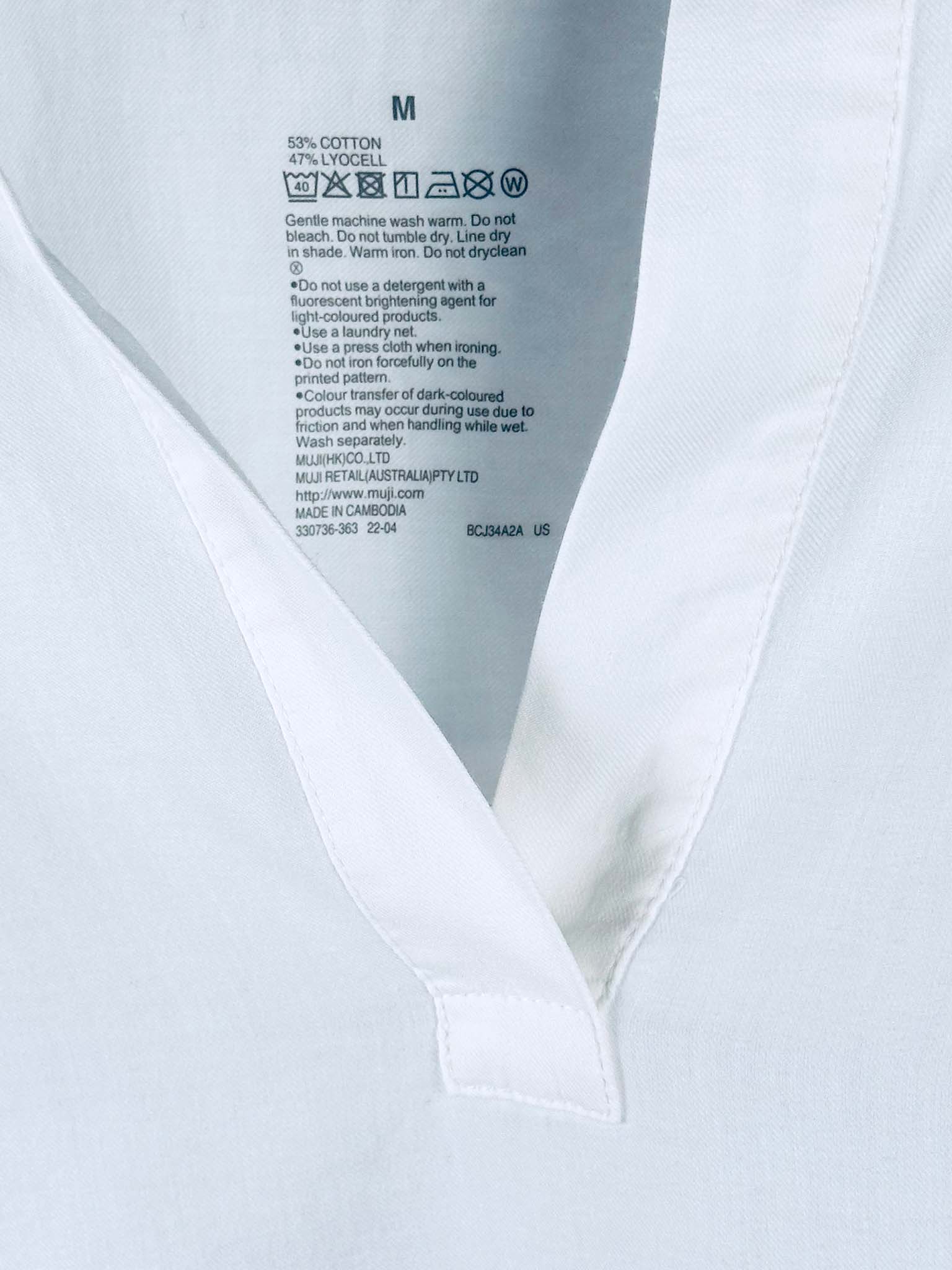 Close-up of a white shirt with a label on the collar