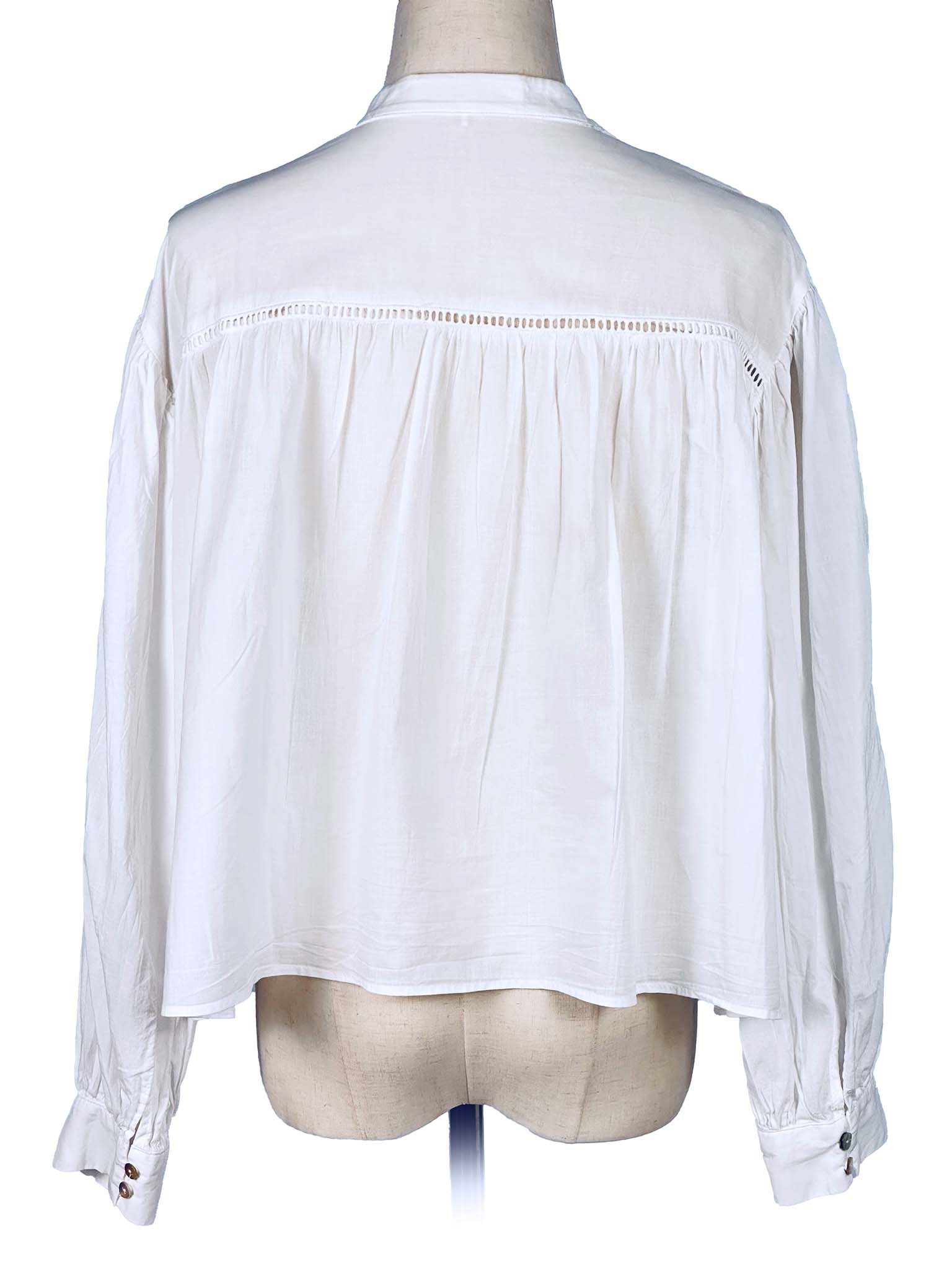 White blouse on a mannequin with a plain background