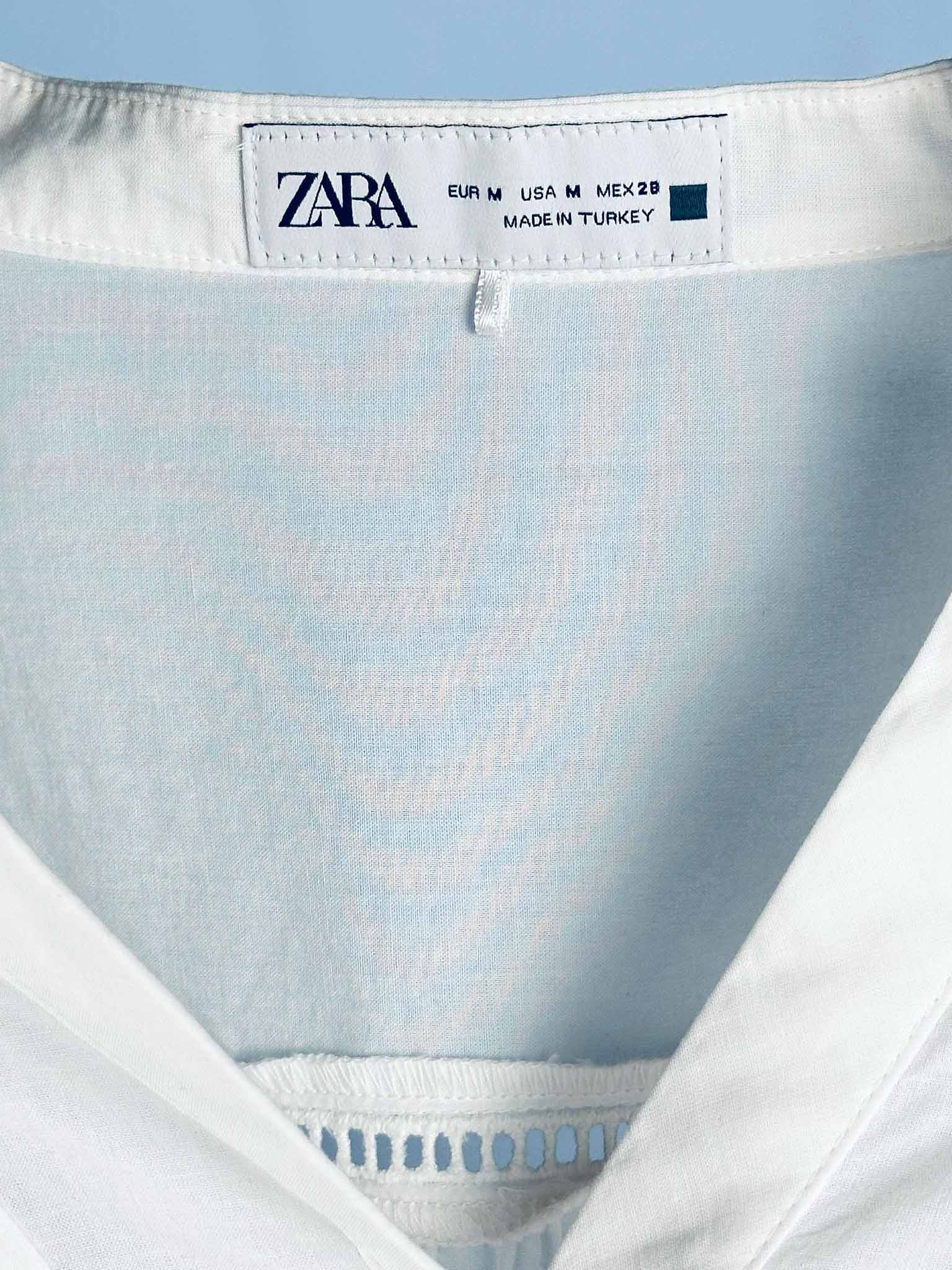 Zara label on a garment with a light blue background