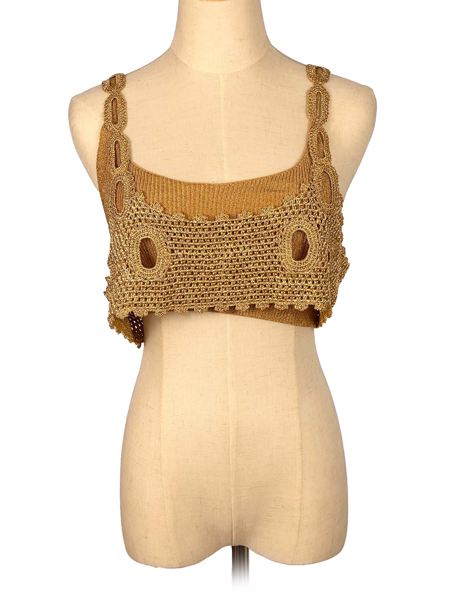 Golden crochet crop top on a mannequin against a white background