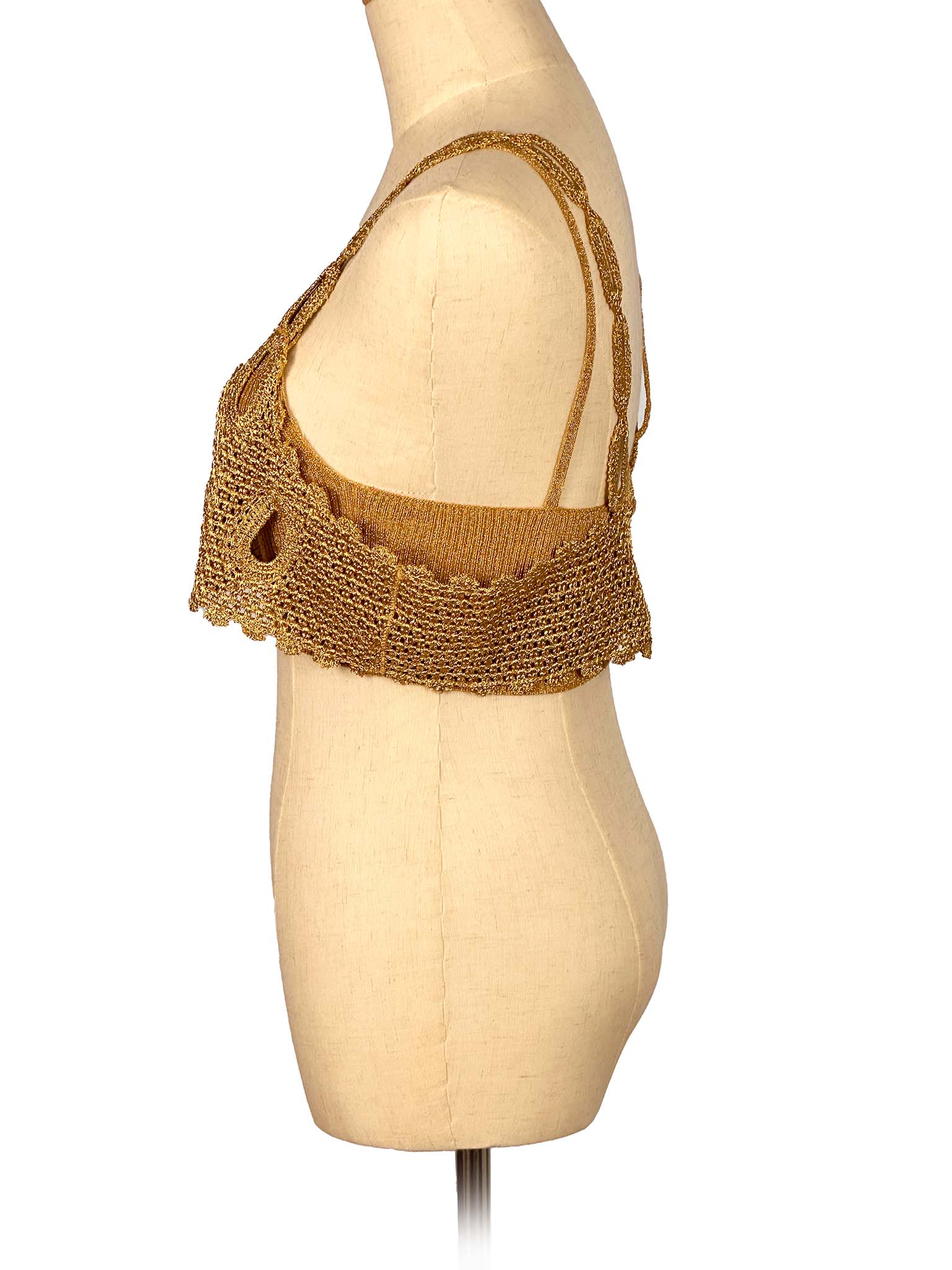 Gold mesh top on a mannequin against a white background