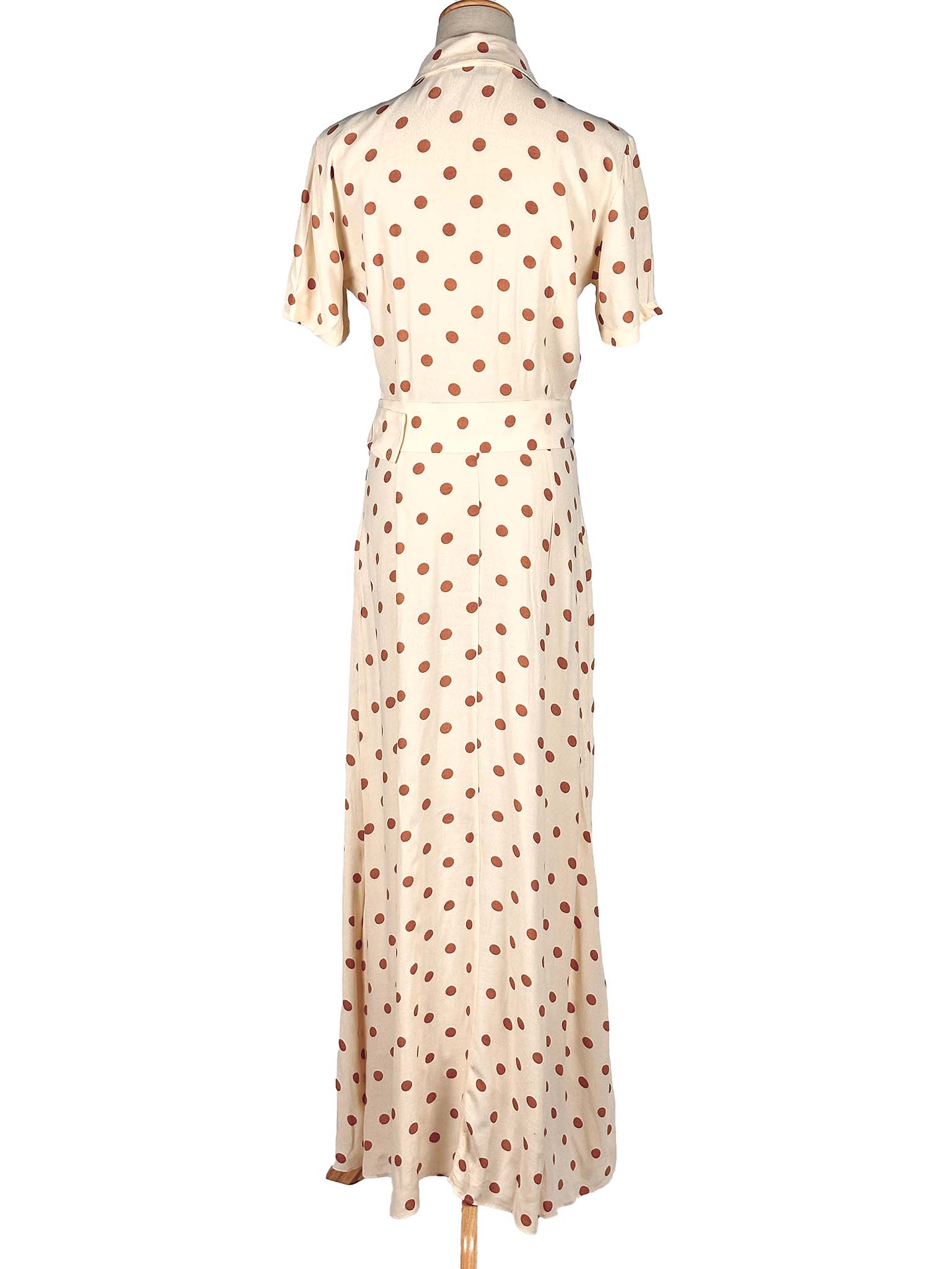 White Zara dress with brown polka dots on a mannequin against a white background
