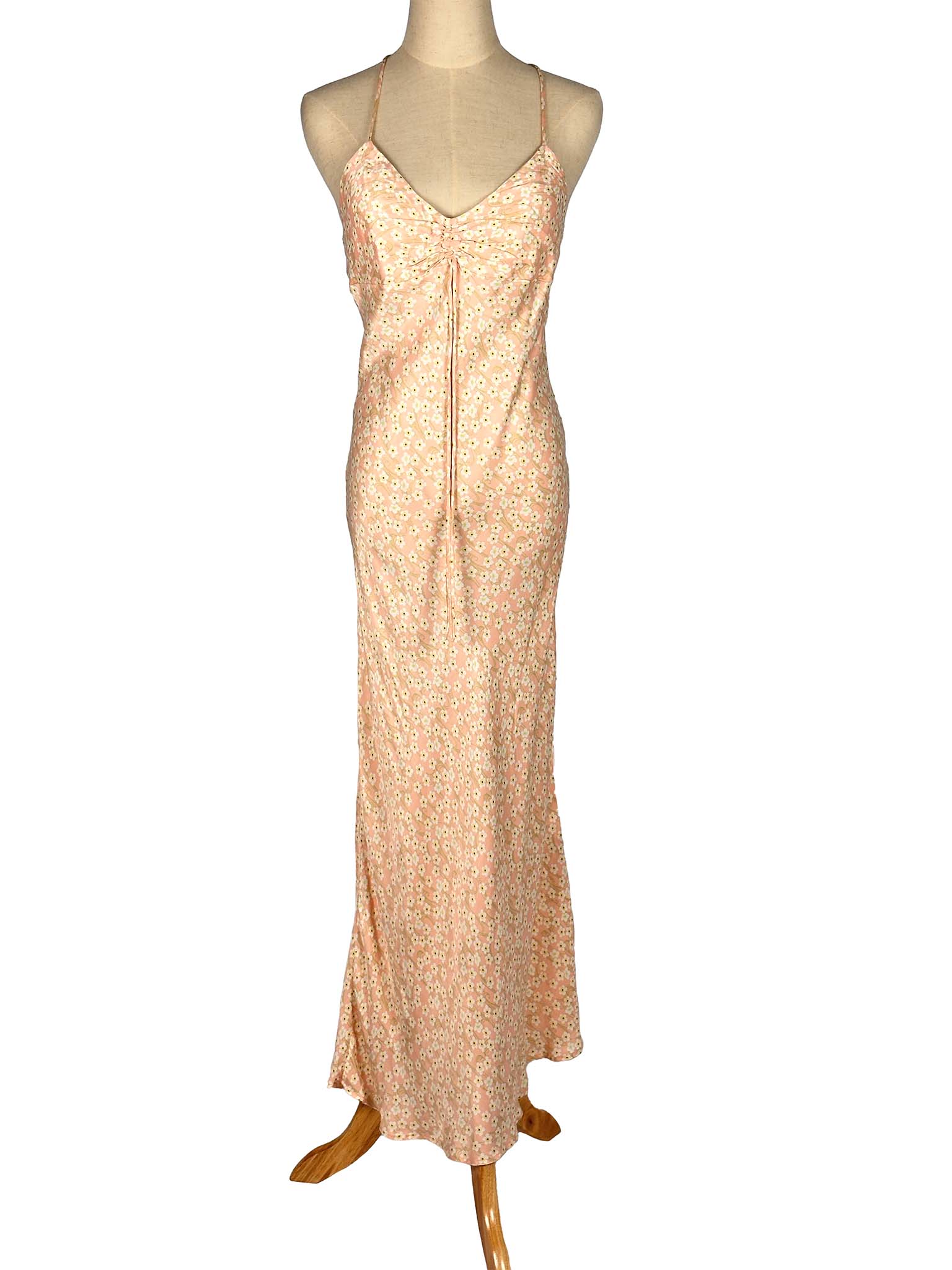 Pink floral slip dress on a mannequin against a white background