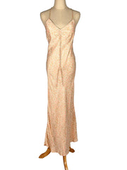 Pink floral slip dress on a mannequin against a white background