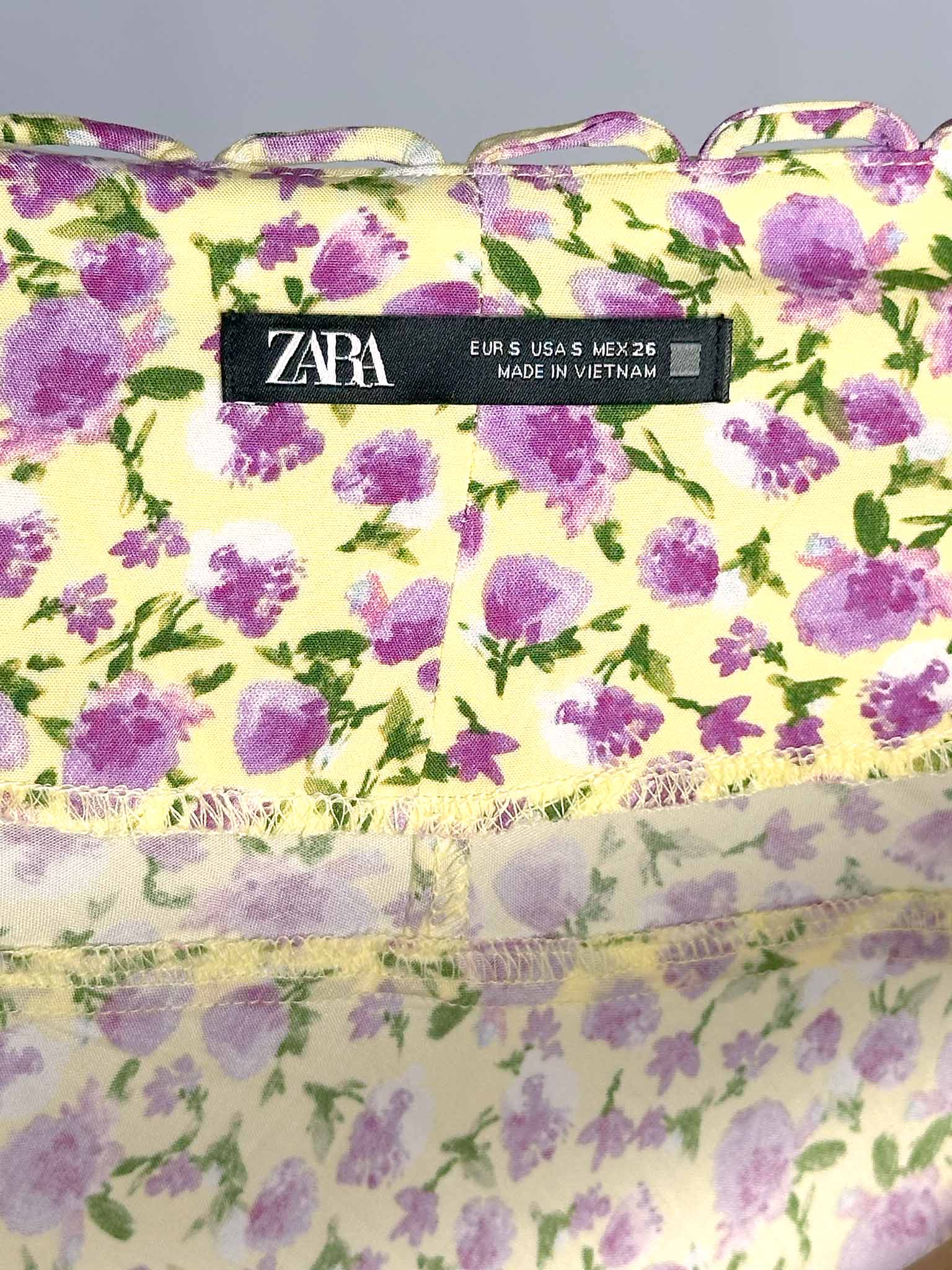 Floral-patterned bag with Zara branding on a gray background