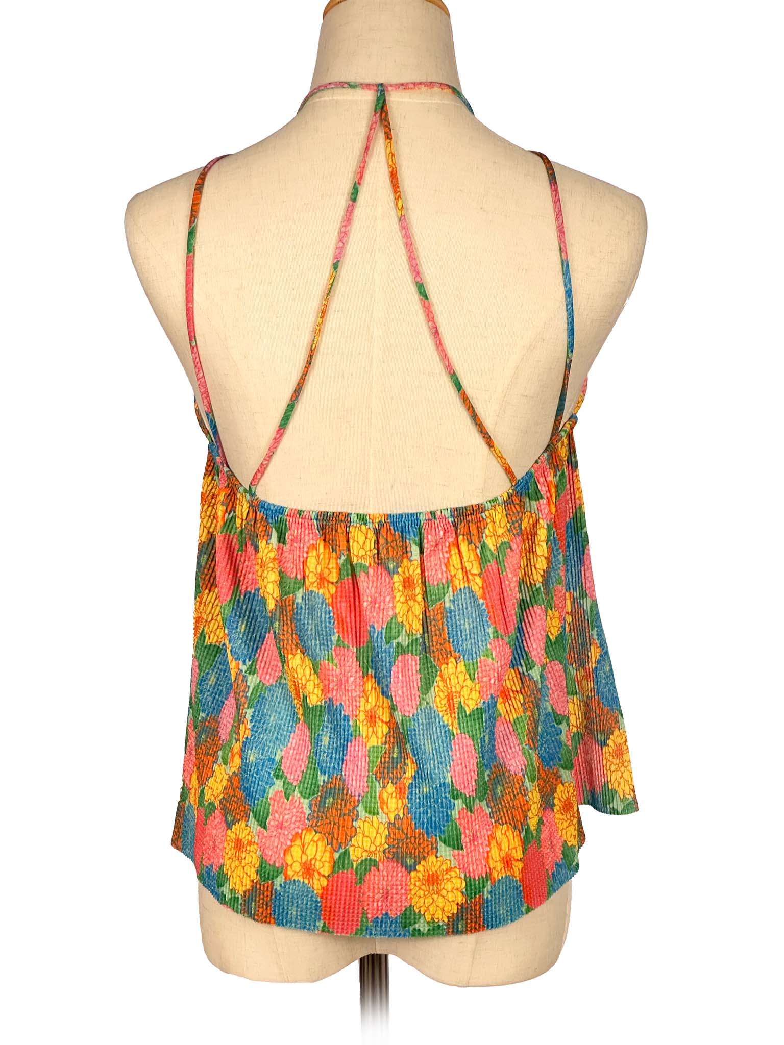 Colorful floral-patterned top on a mannequin with a white background