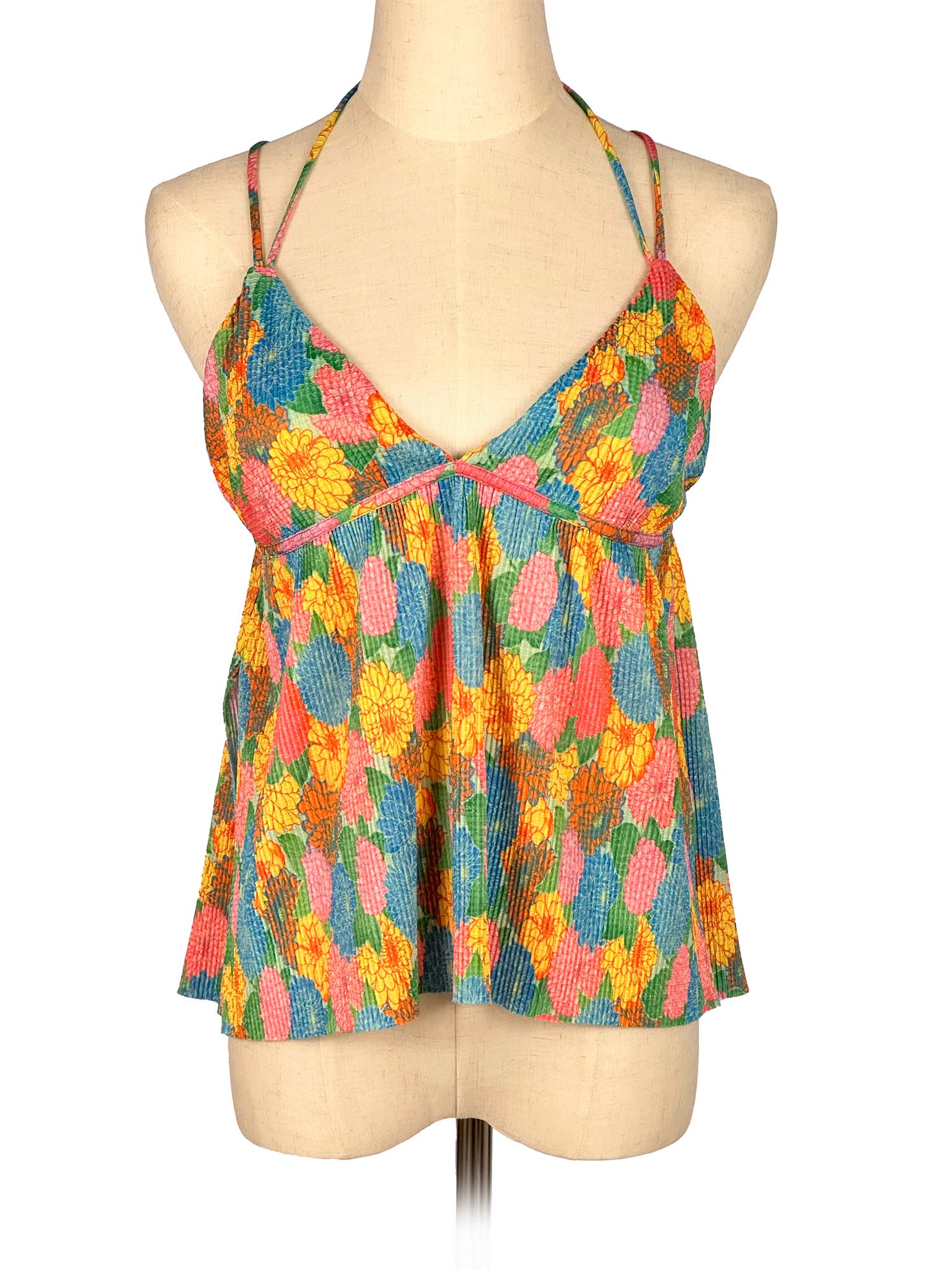 Colorful floral-patterned top on a mannequin against a white background