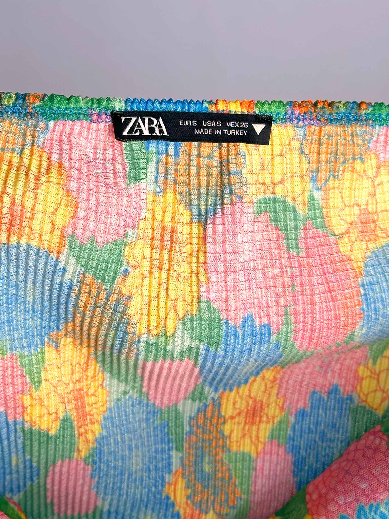 Colorful patterned fabric with Zara label on a gray background