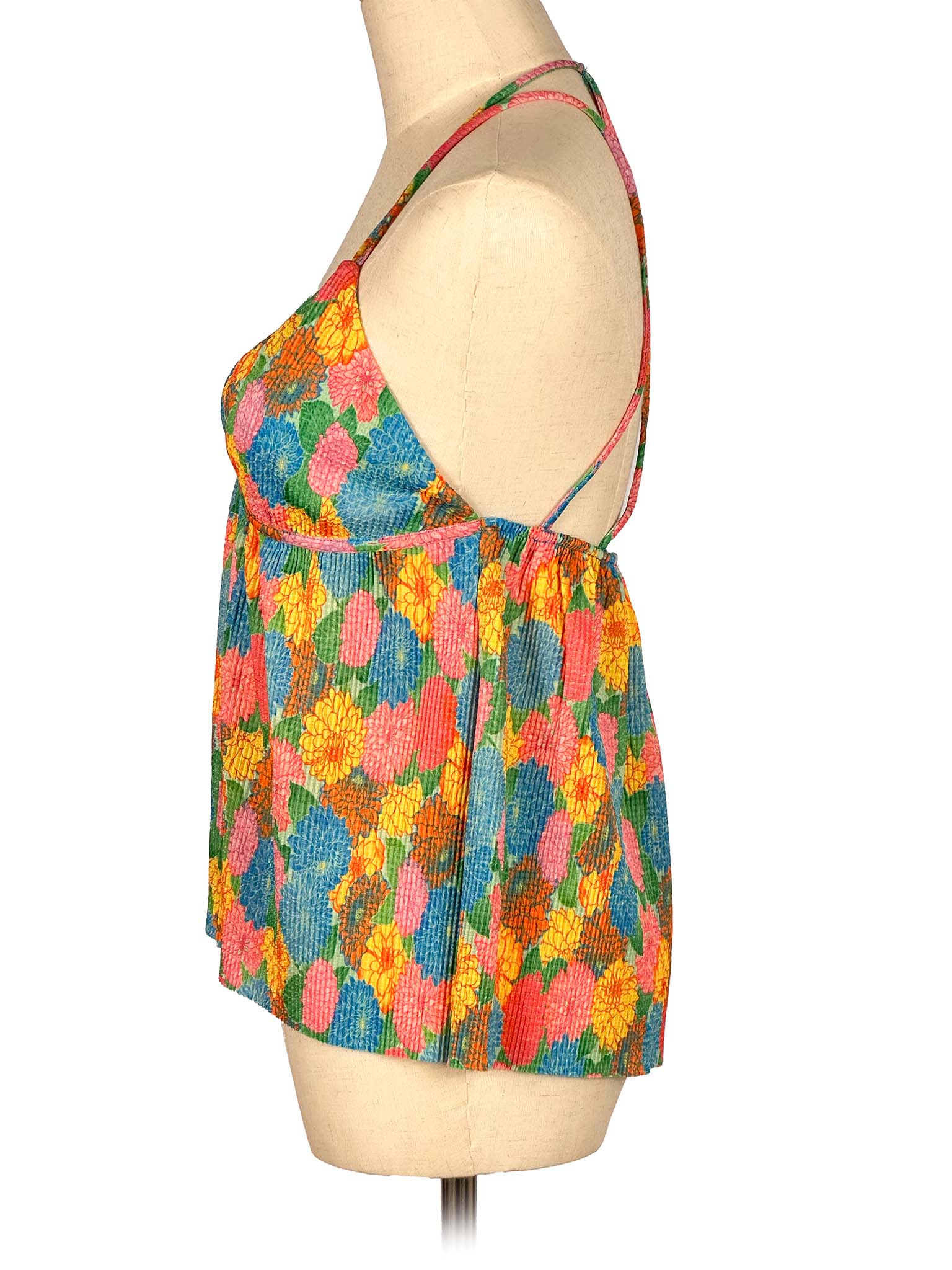 Colorful floral dress on a mannequin against a white background