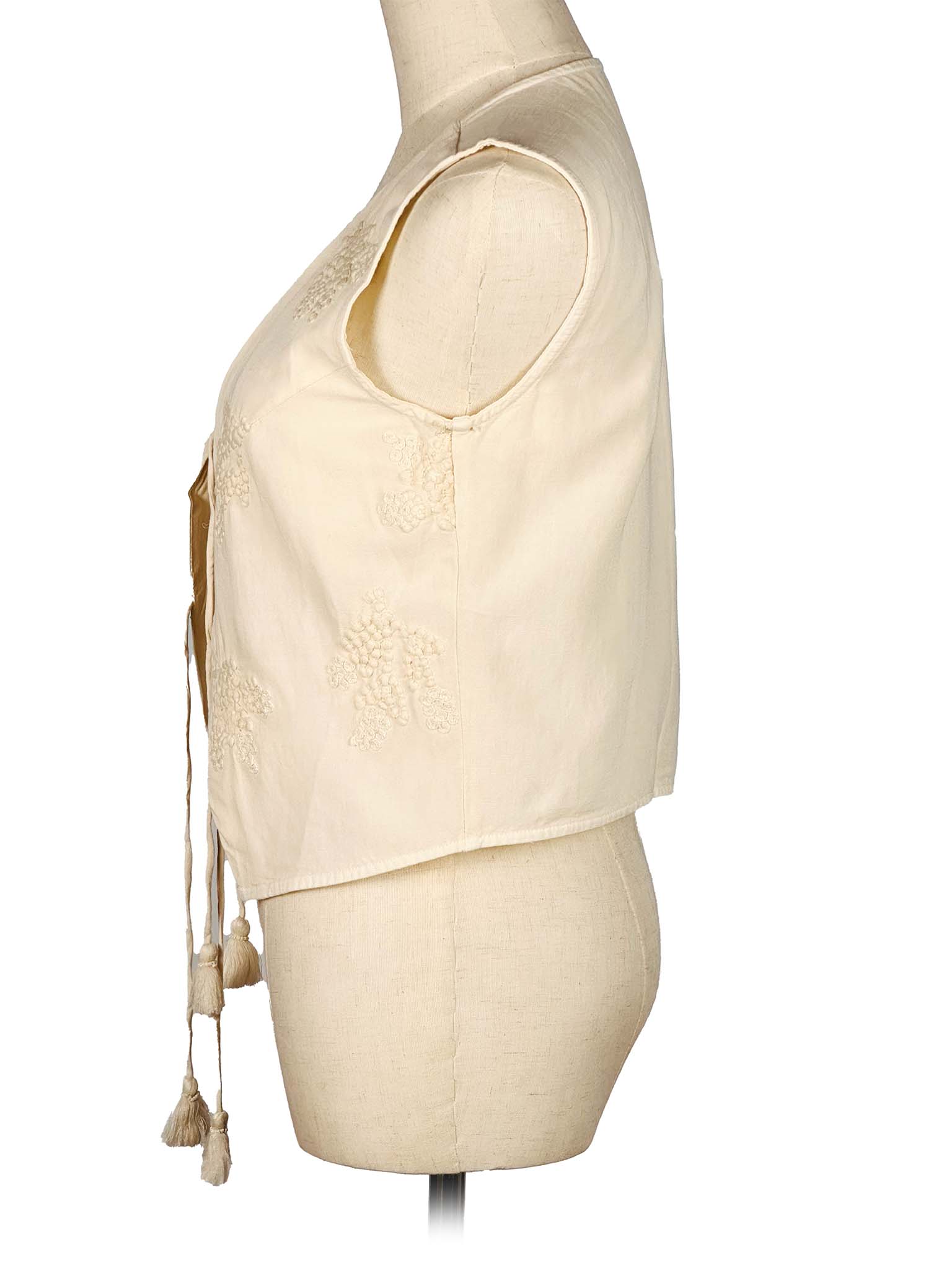 White embroidered vest on a mannequin against a white background