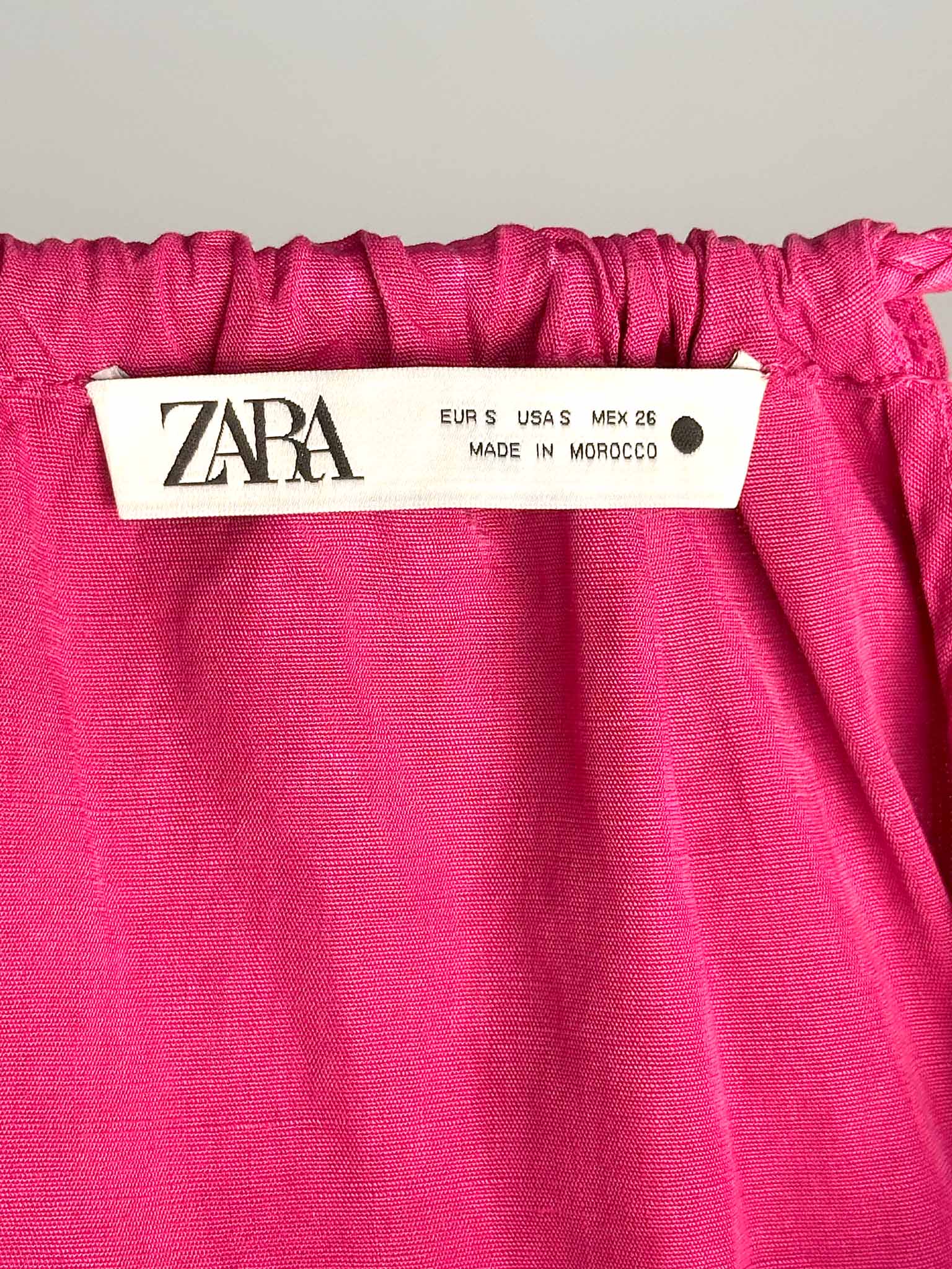Zara label on a pink fabric background