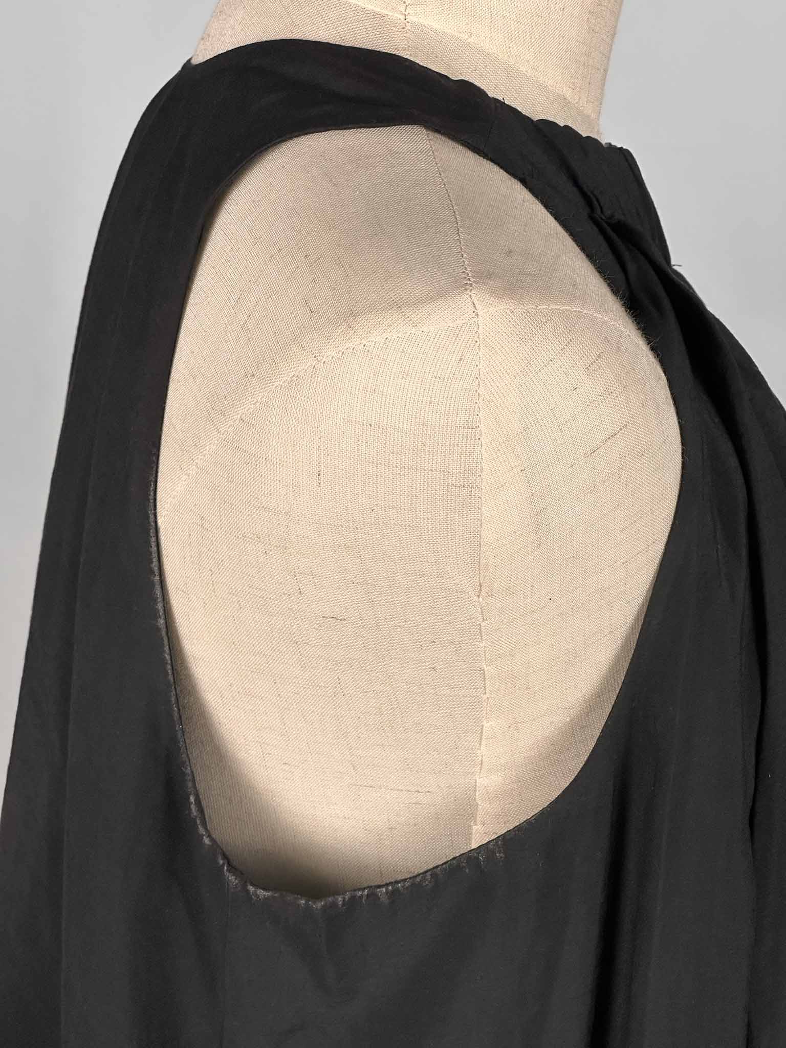 COS dark grey halter neck dress on a mannequin against a white background