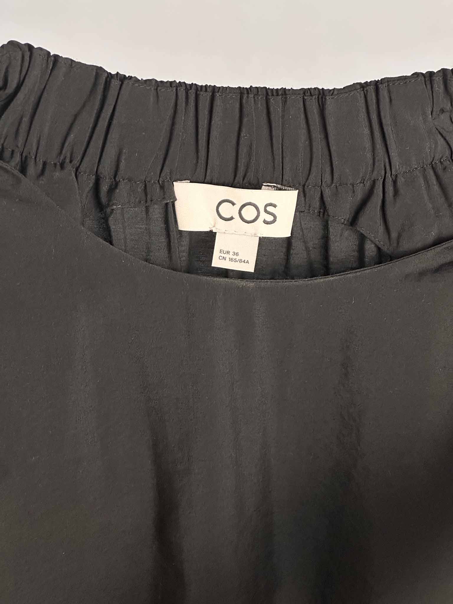 COS dark grey halter neck dress on a mannequin against a white background