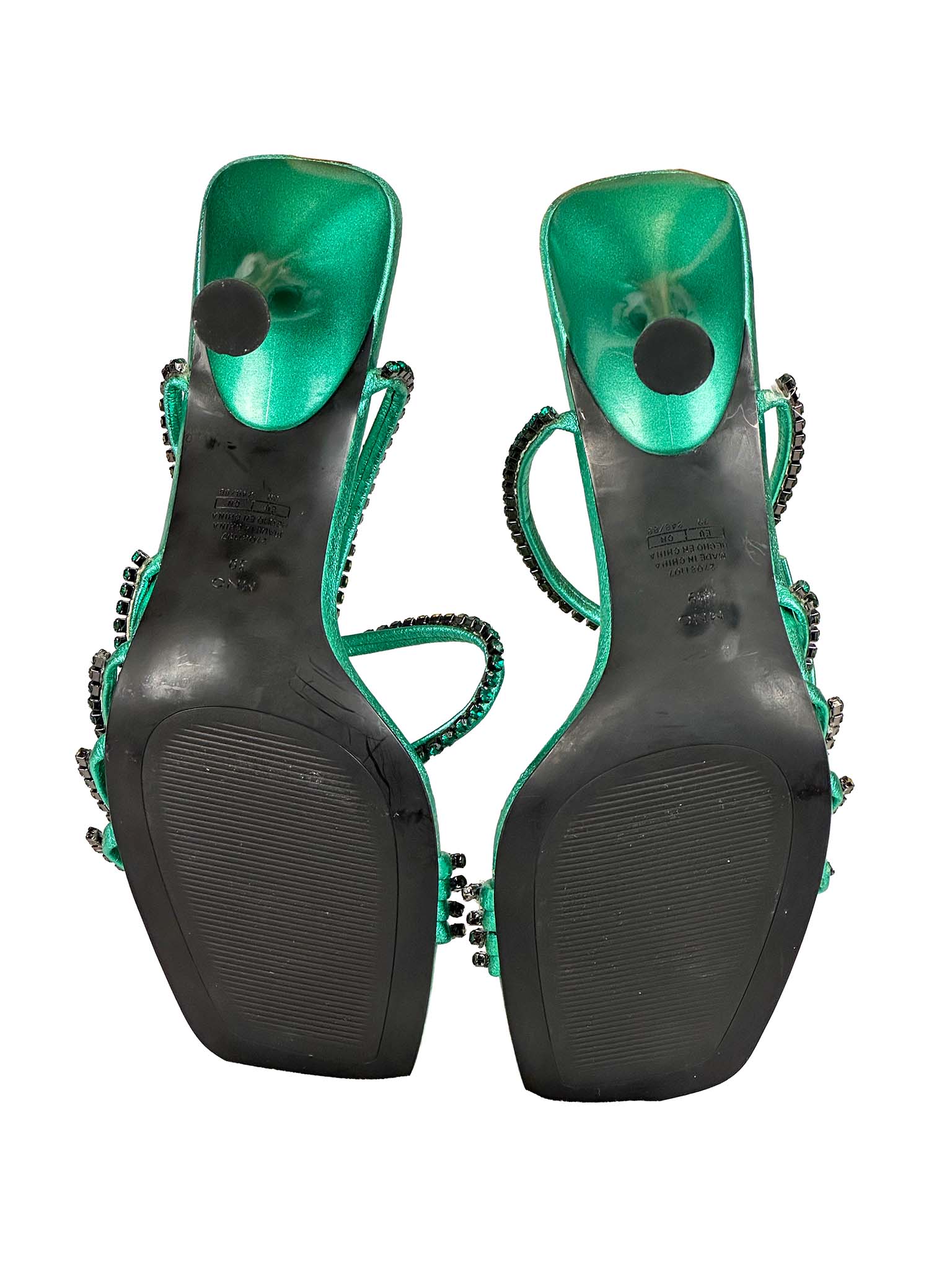 Pair of green high-heeled Mango shoes with embellishments on a white background