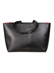 Mansur Gavriel black tote bag with red interior lining on a white background