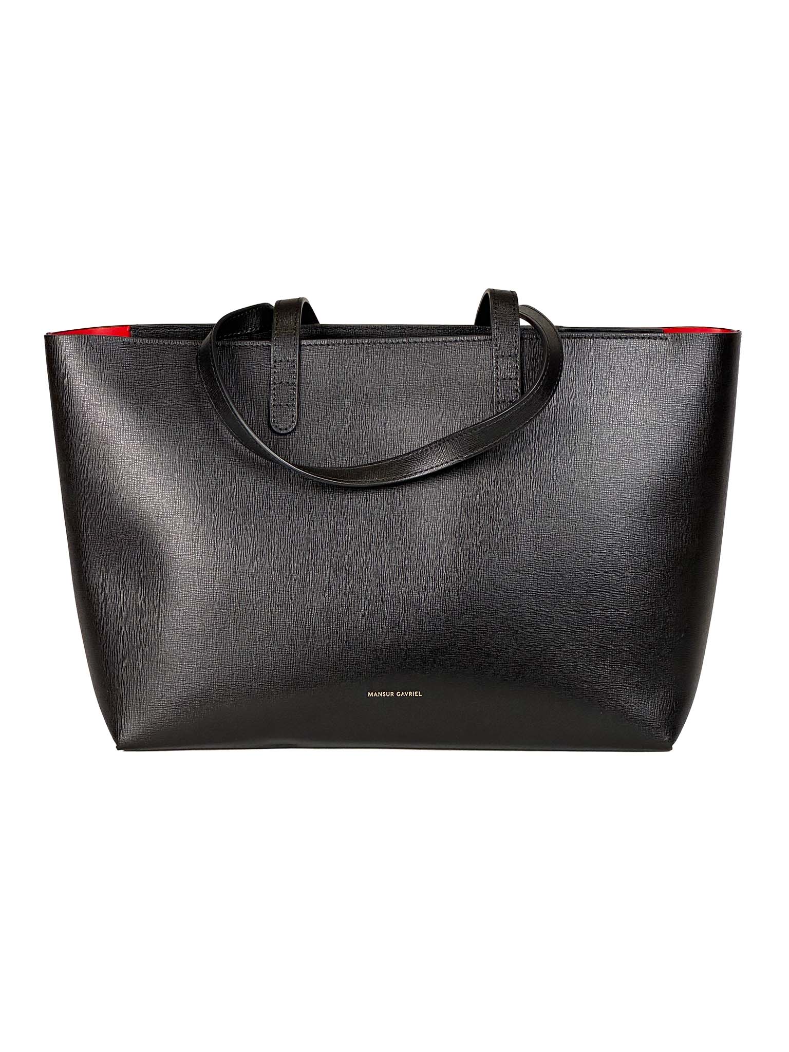 Mansur Gavriel black tote bag with red interior lining on a white background
