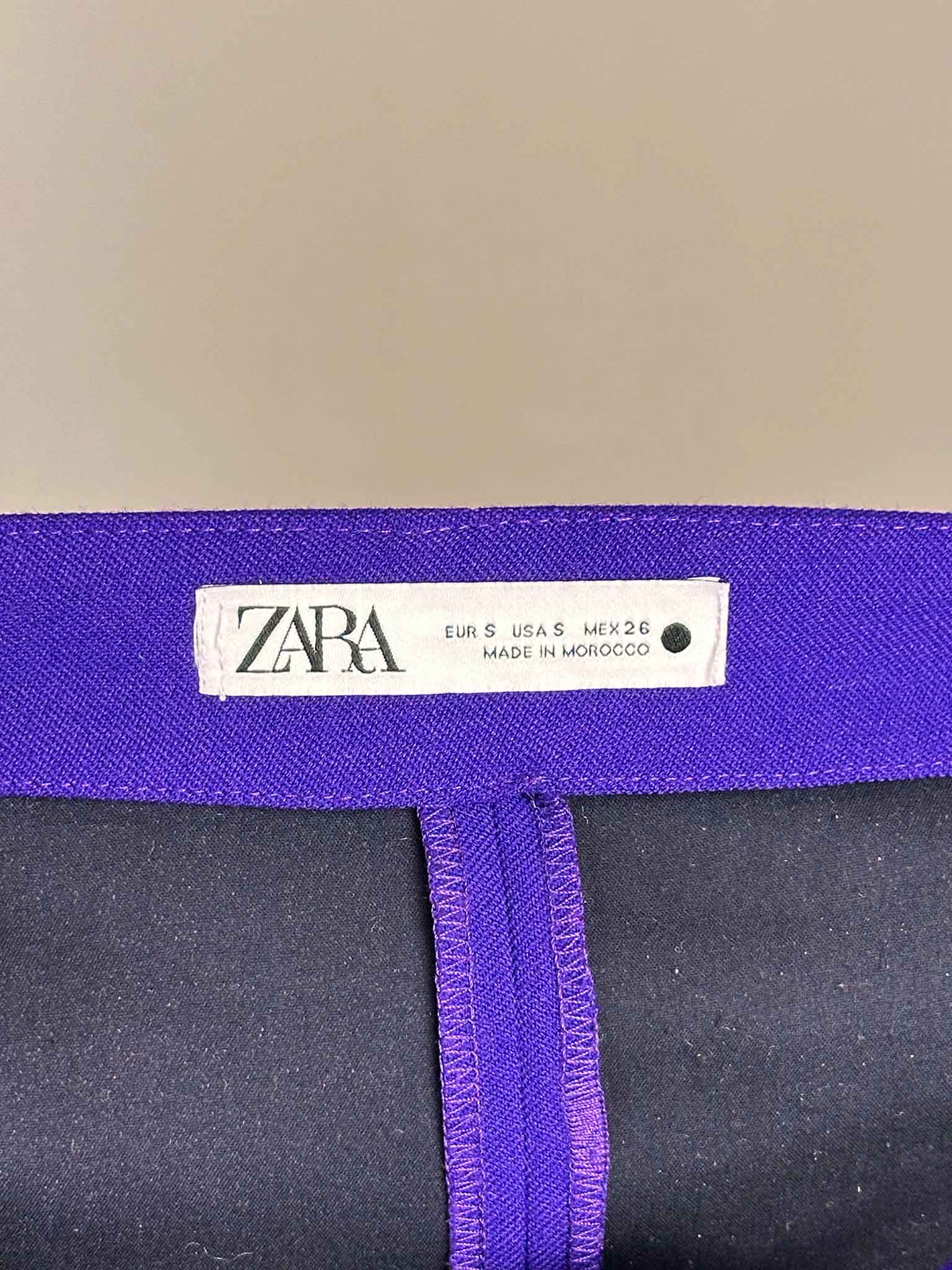 Zara label on a purple garment with black fabric