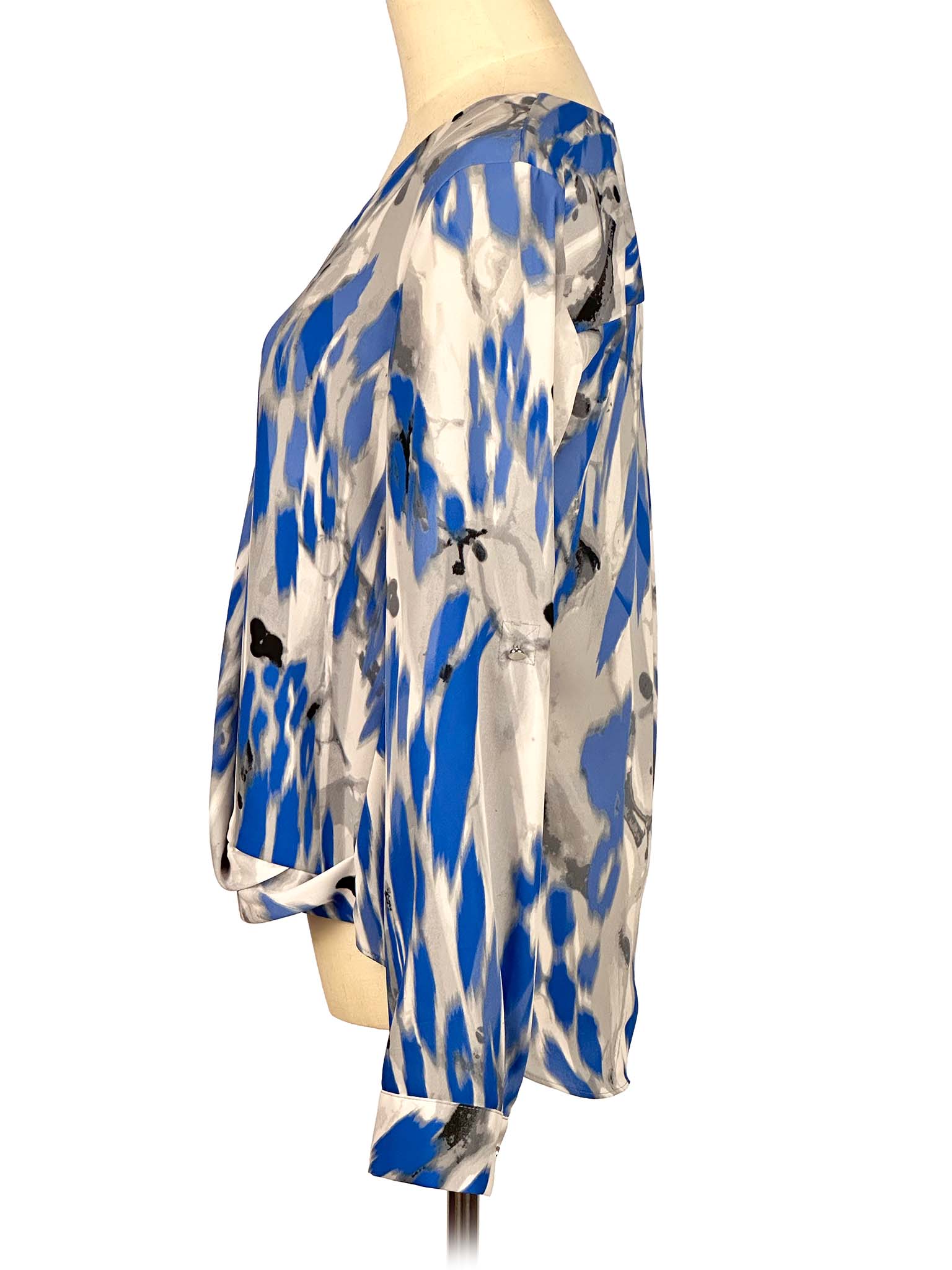 Blue and gray patterned Alfani blouse on a mannequin against a white background