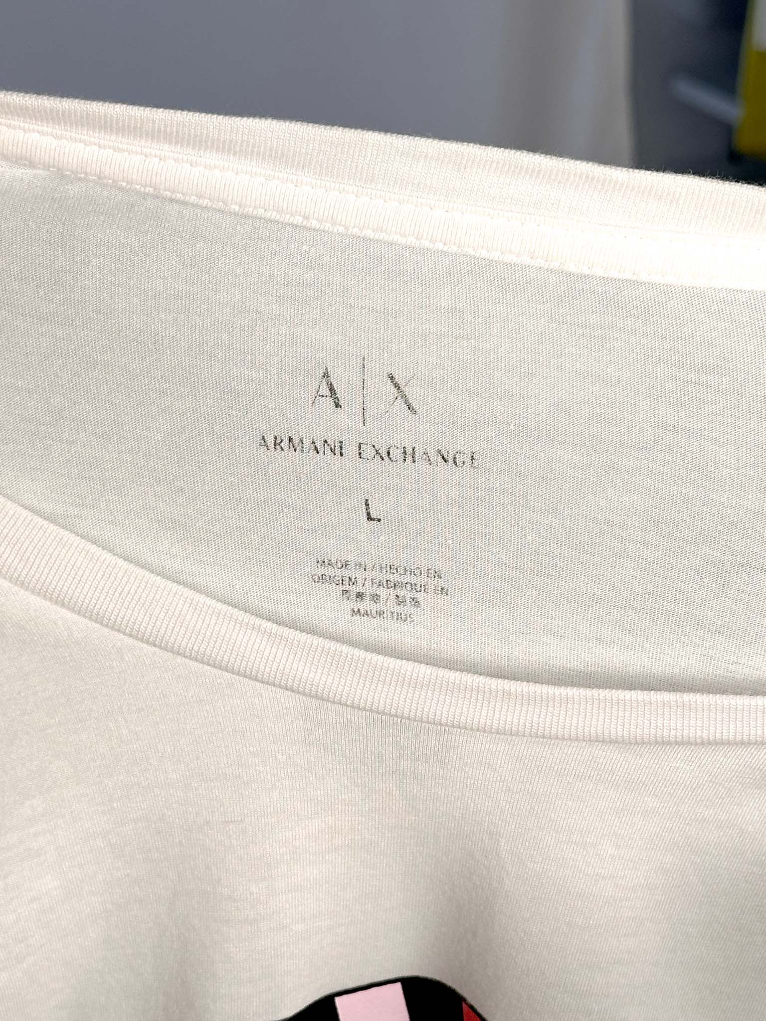 Close-up of Armani Exchange label on a garment with a blurred background