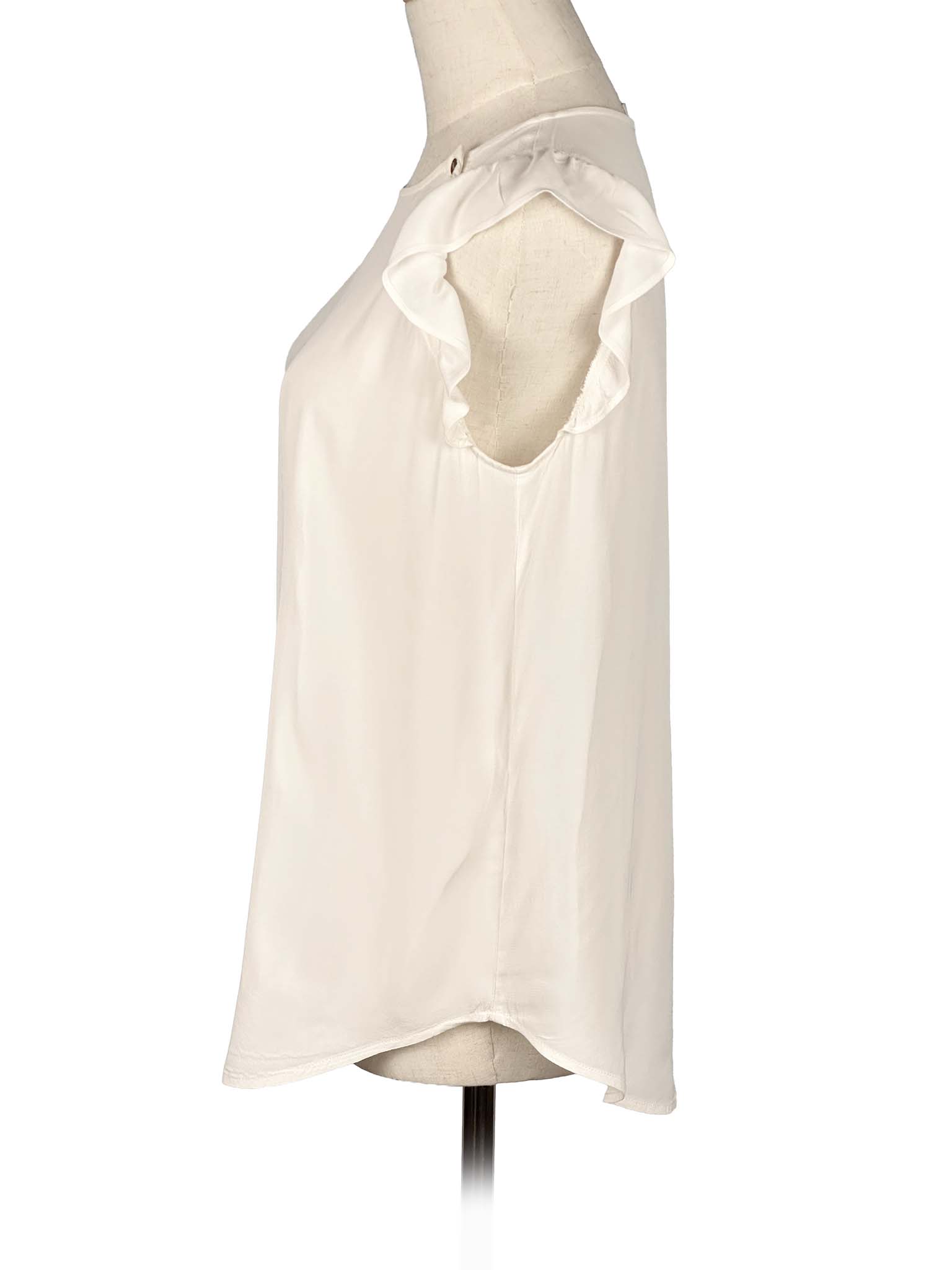 White sleeveless Loft top with ruffled shoulders on a mannequin against a white background