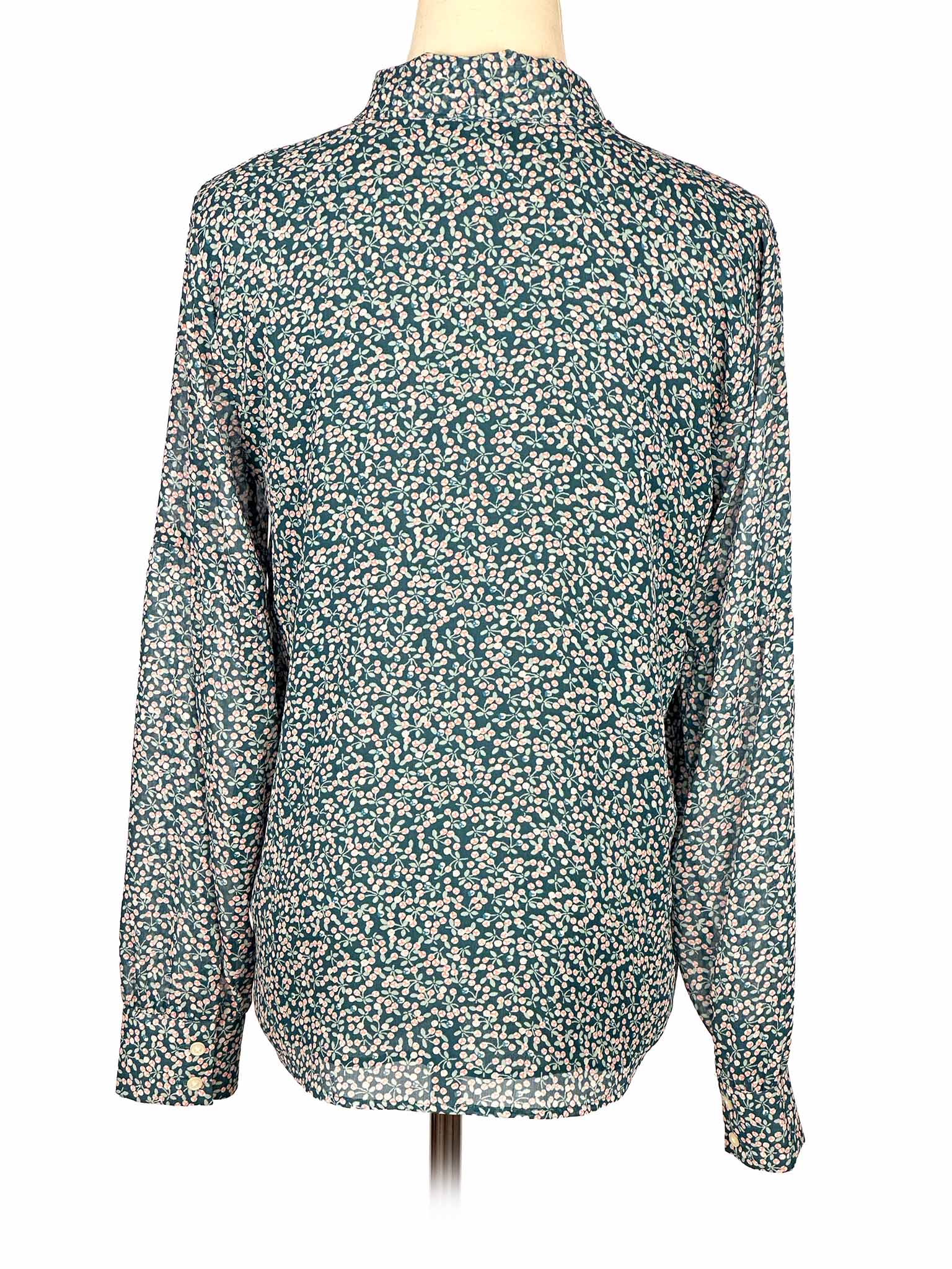 Floral-patterned green Loft blouse on a mannequin against a white background