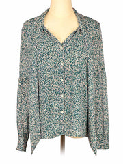 Floral-patterned green Loft blouse on a mannequin against a white background
