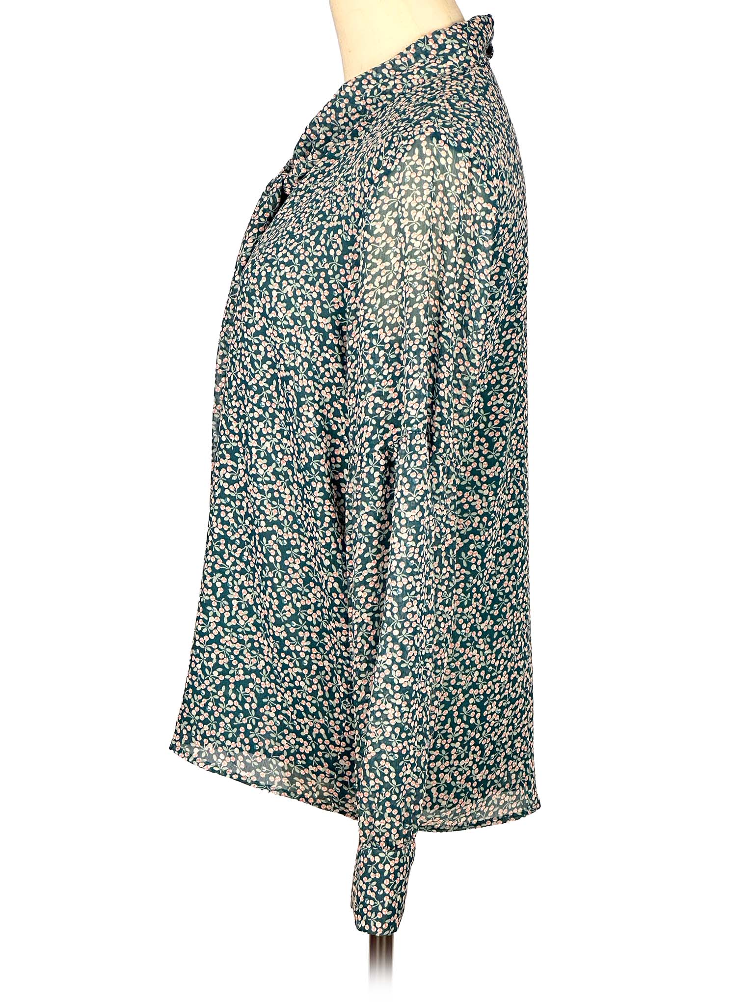 Floral-patterned green Loft blouse on a mannequin against a white background