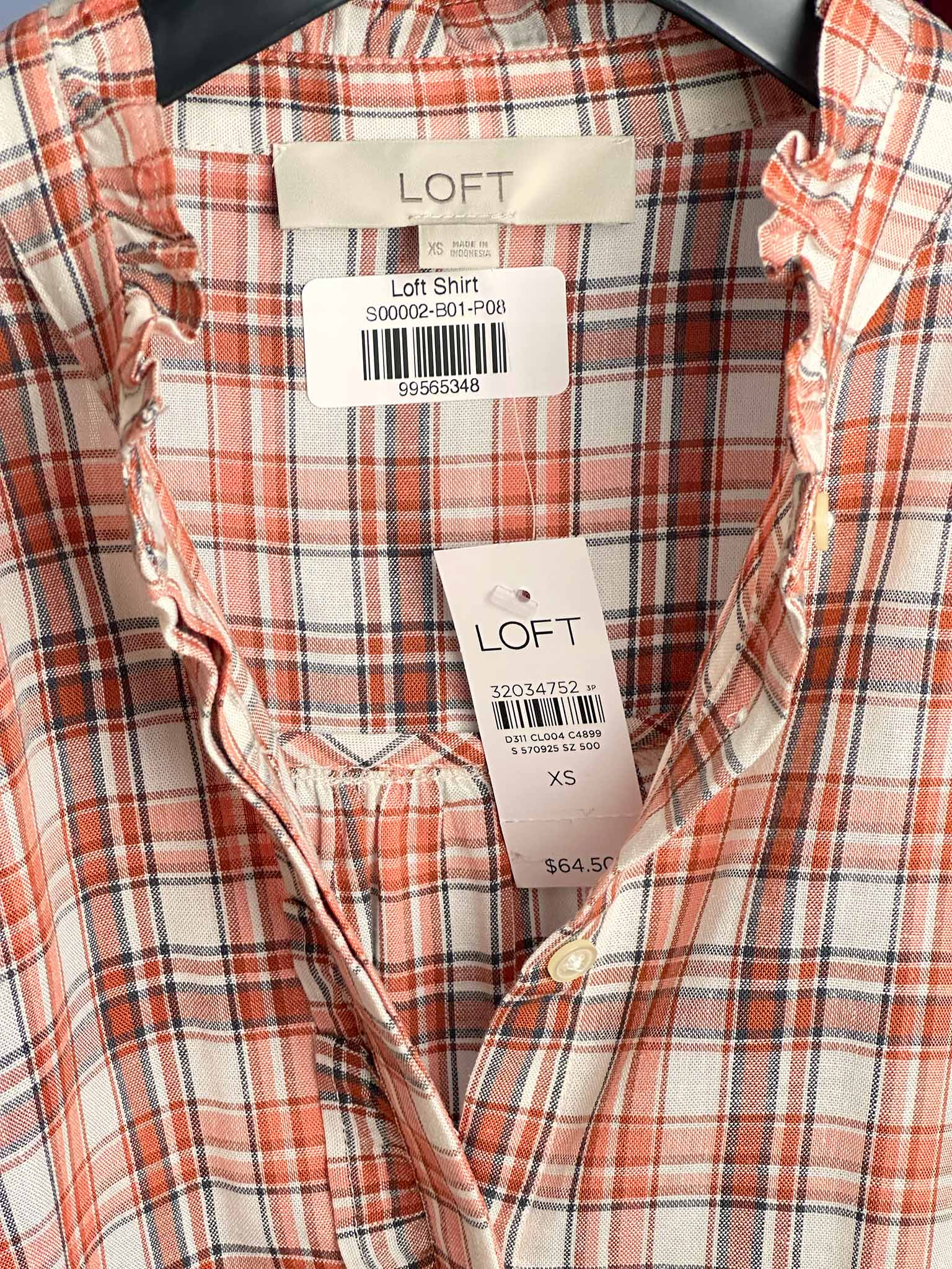 Plaid shirt with LOFT tags on a checkered background
