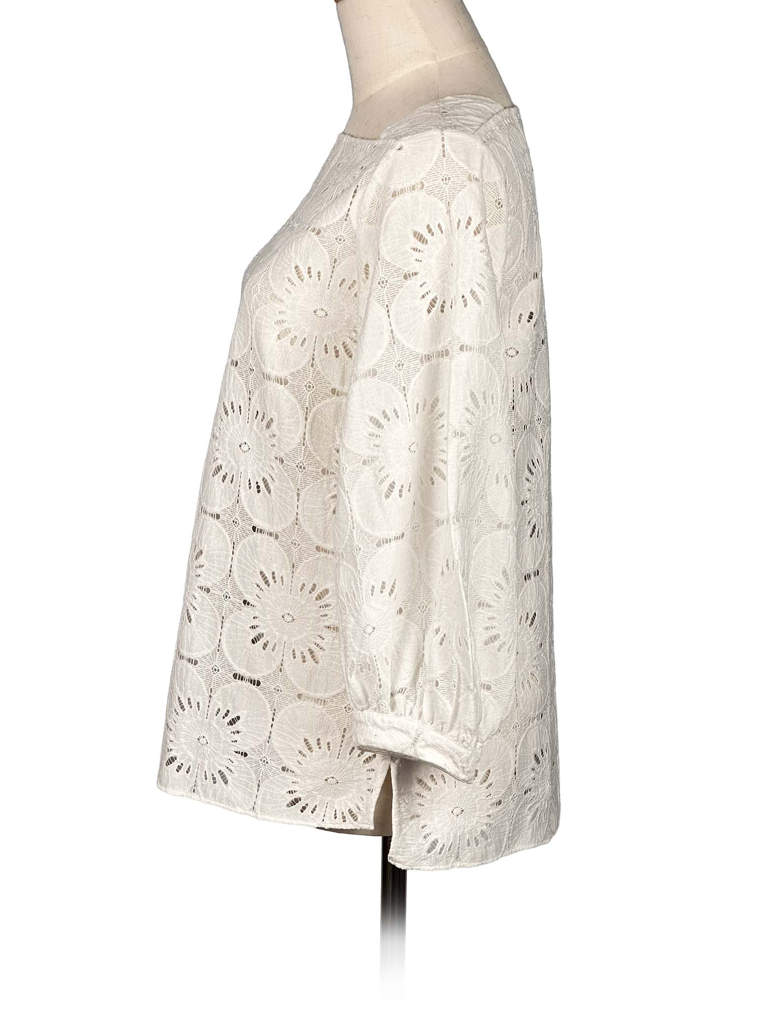 Beige Massimo Dutti lace blouse on a mannequin against a white background