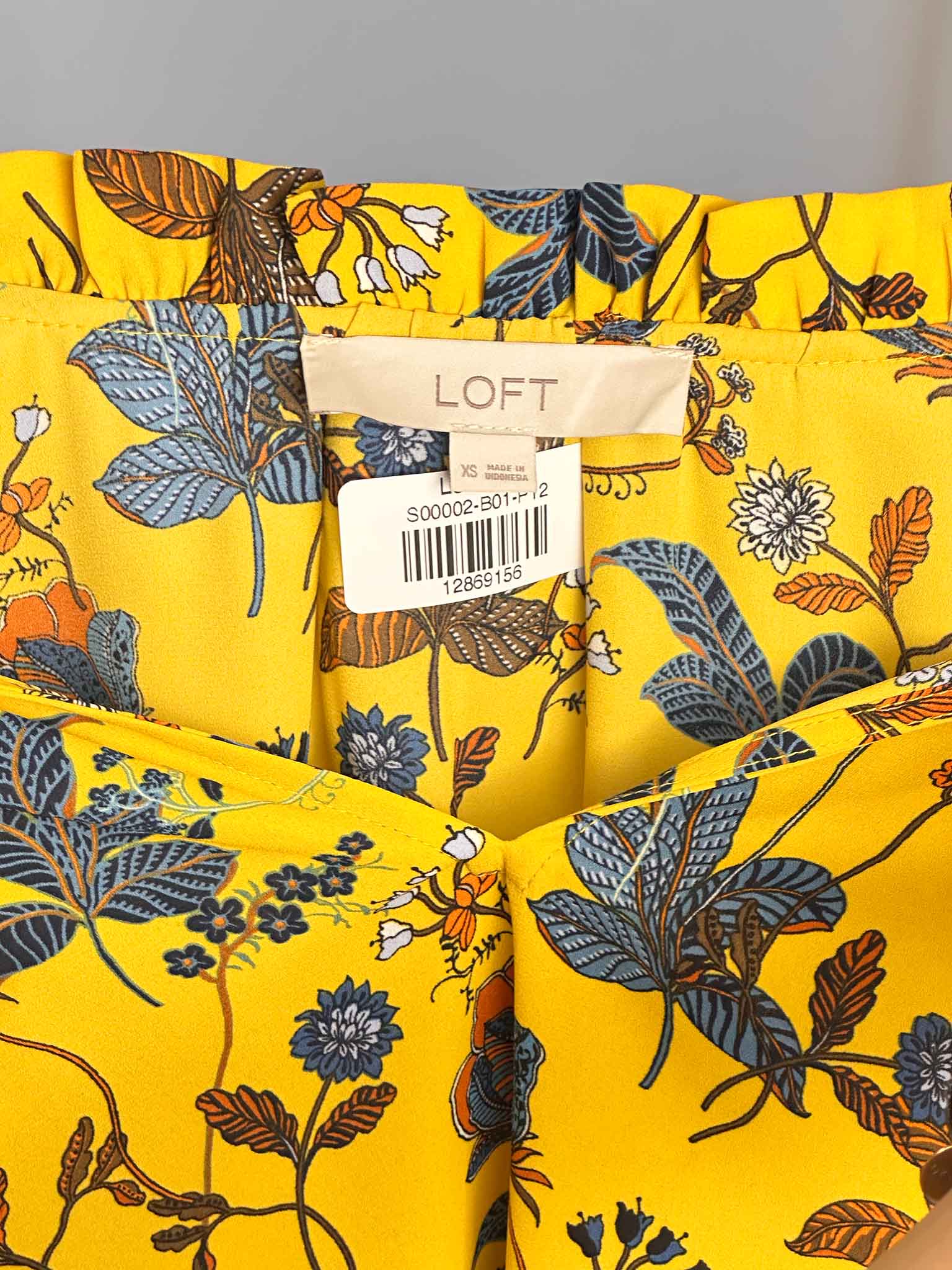Yellow fabric with floral pattern and LOFT label