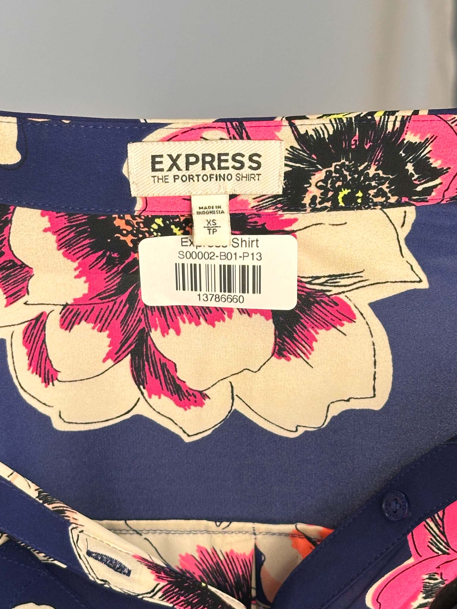 Floral shirt with 'Express' label on a gray background