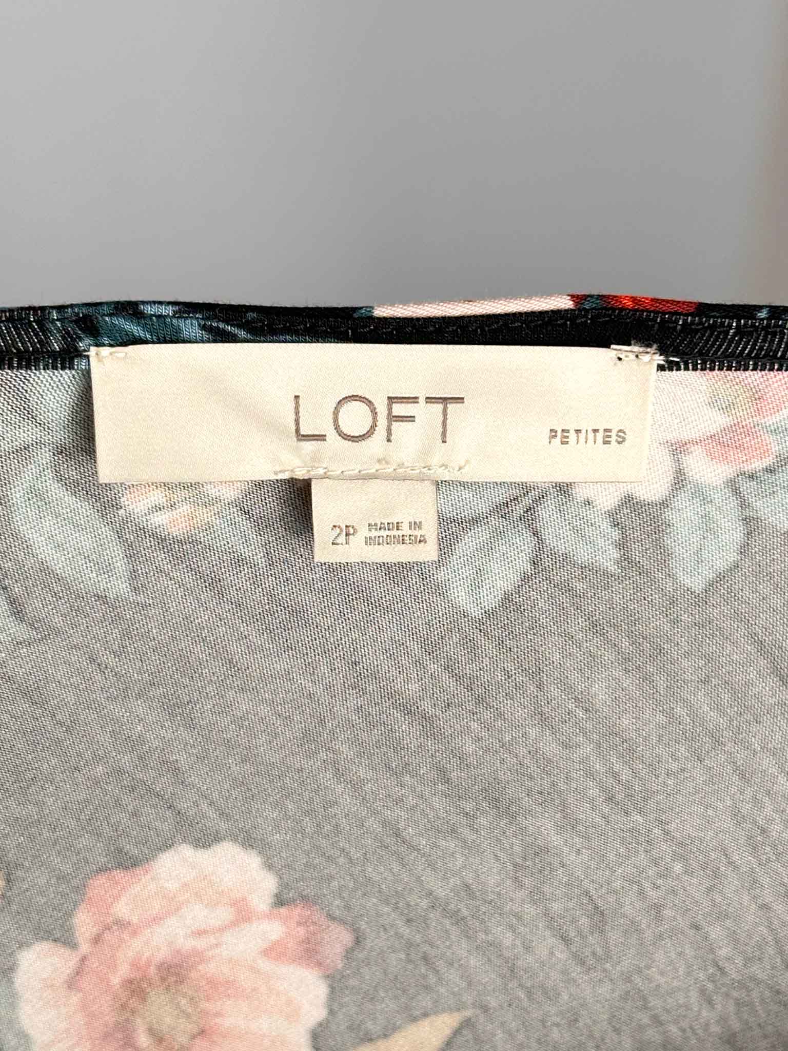 Floral patterned fabric with a LOFT label on a gray background