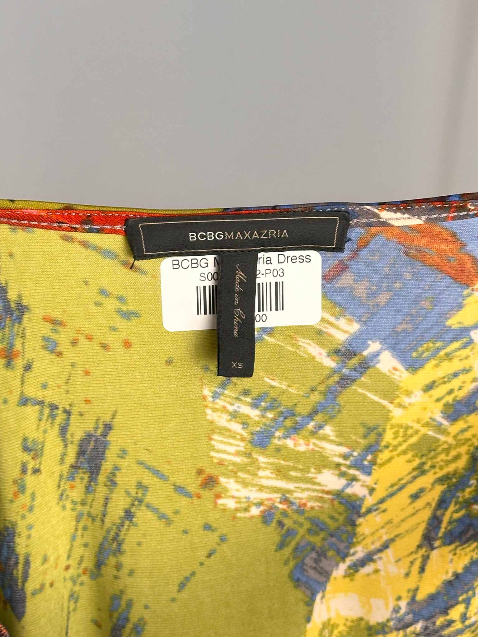 Close-up of a BCBGMAXAZRIA label on a colorful fabric background