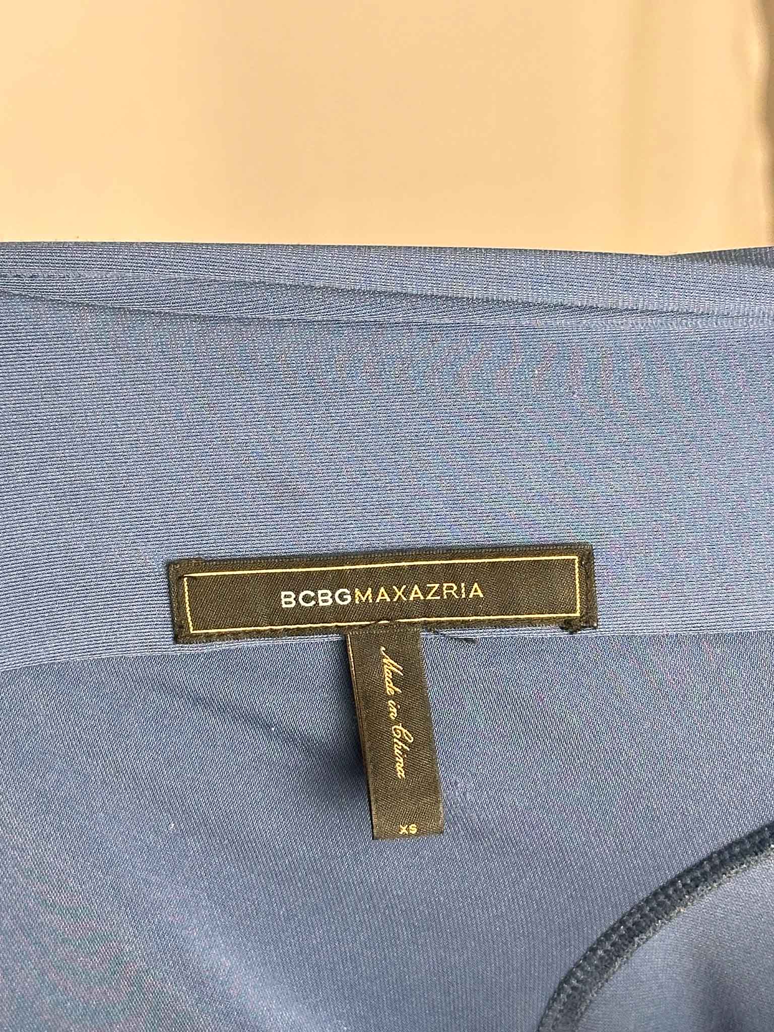 BCBGMaxAzria label on a blue fabric background
