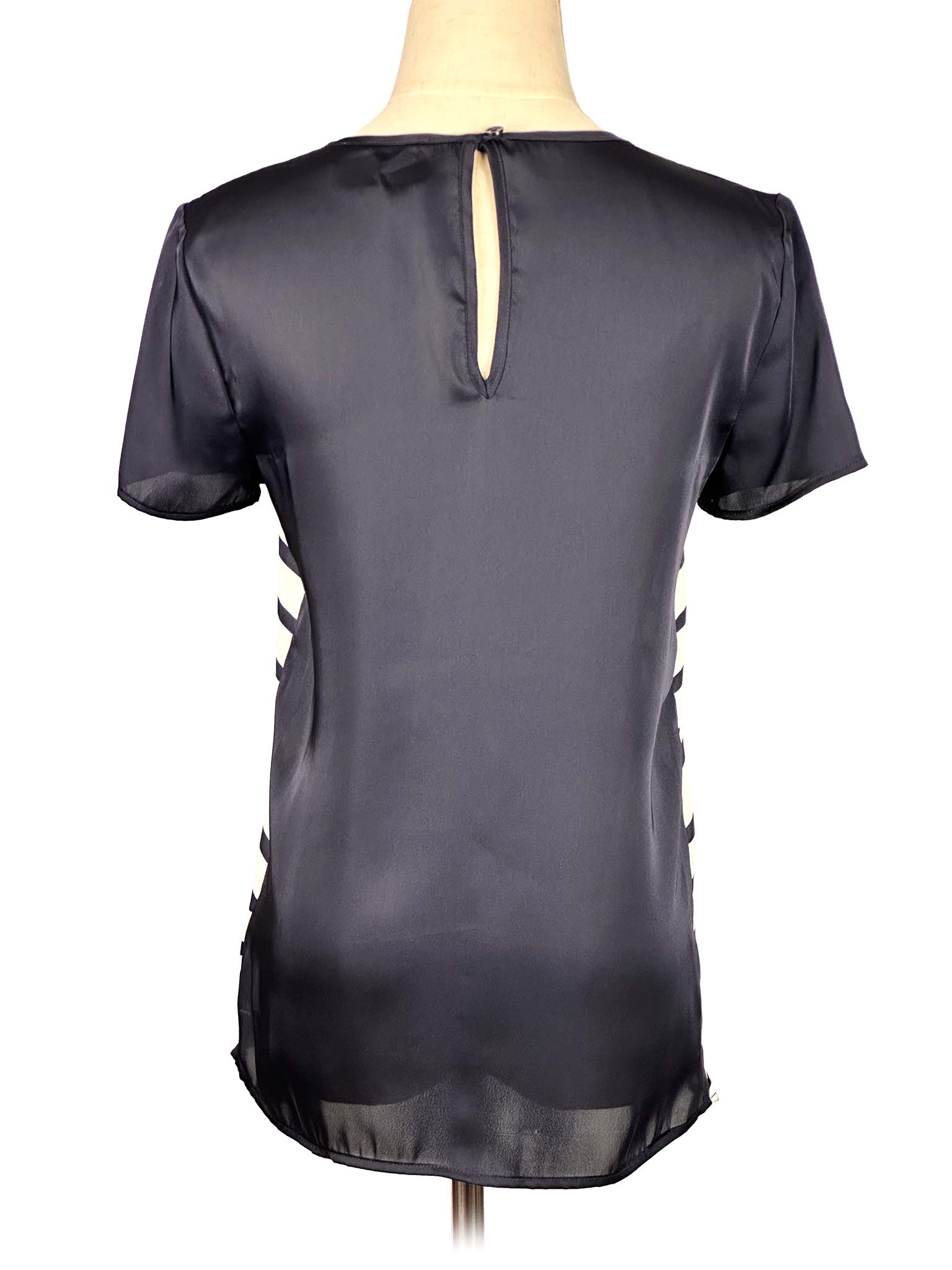 Black and white Michael Kors t-shirt on a mannequin against a white background