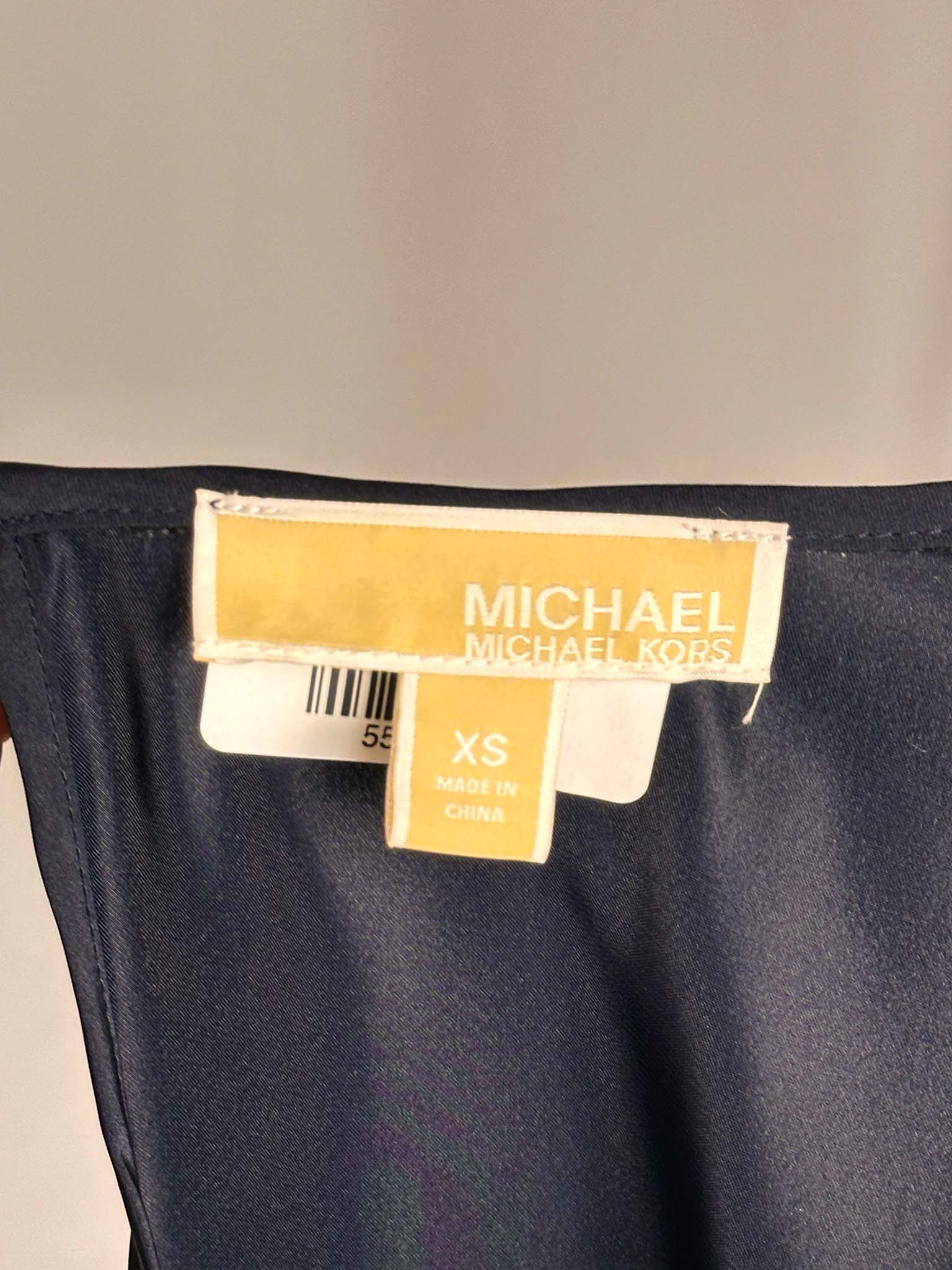 Xs sized T-shirt with a Michael Kors label on a beige background