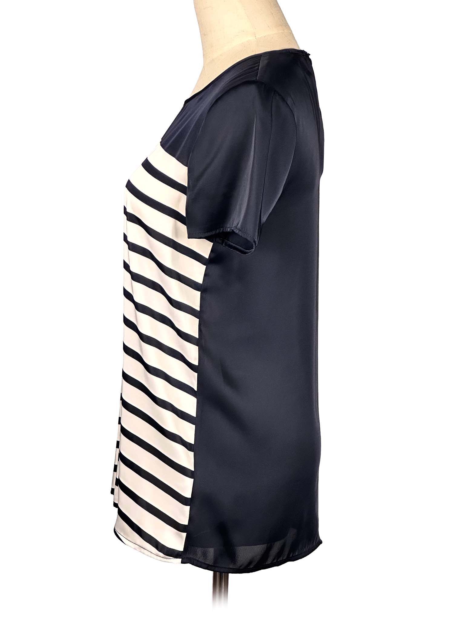 Black and white striped Michael Kors t-shirt on a mannequin against a white background