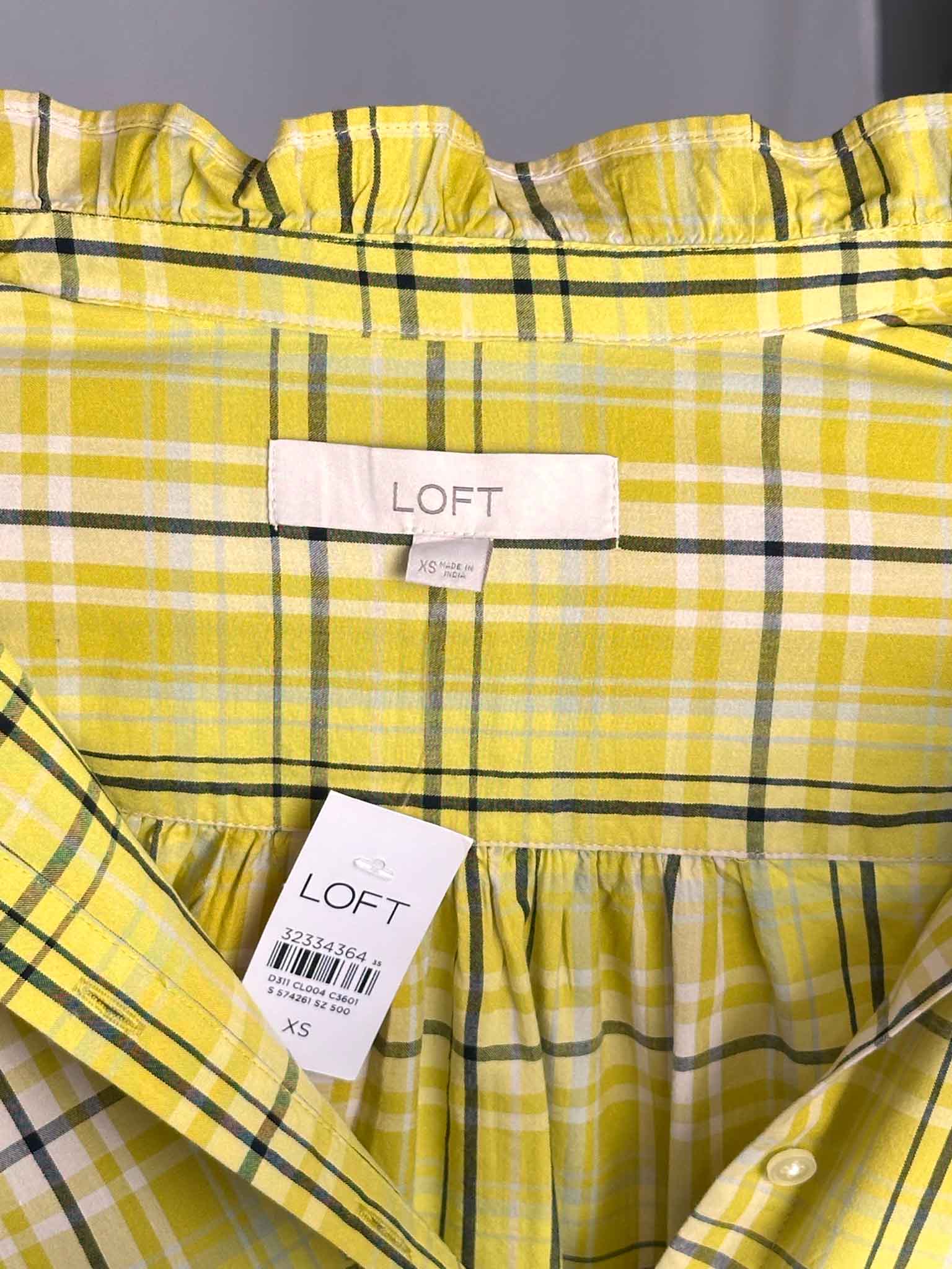 Yellow plaid shirt with LOFT label on a gray background