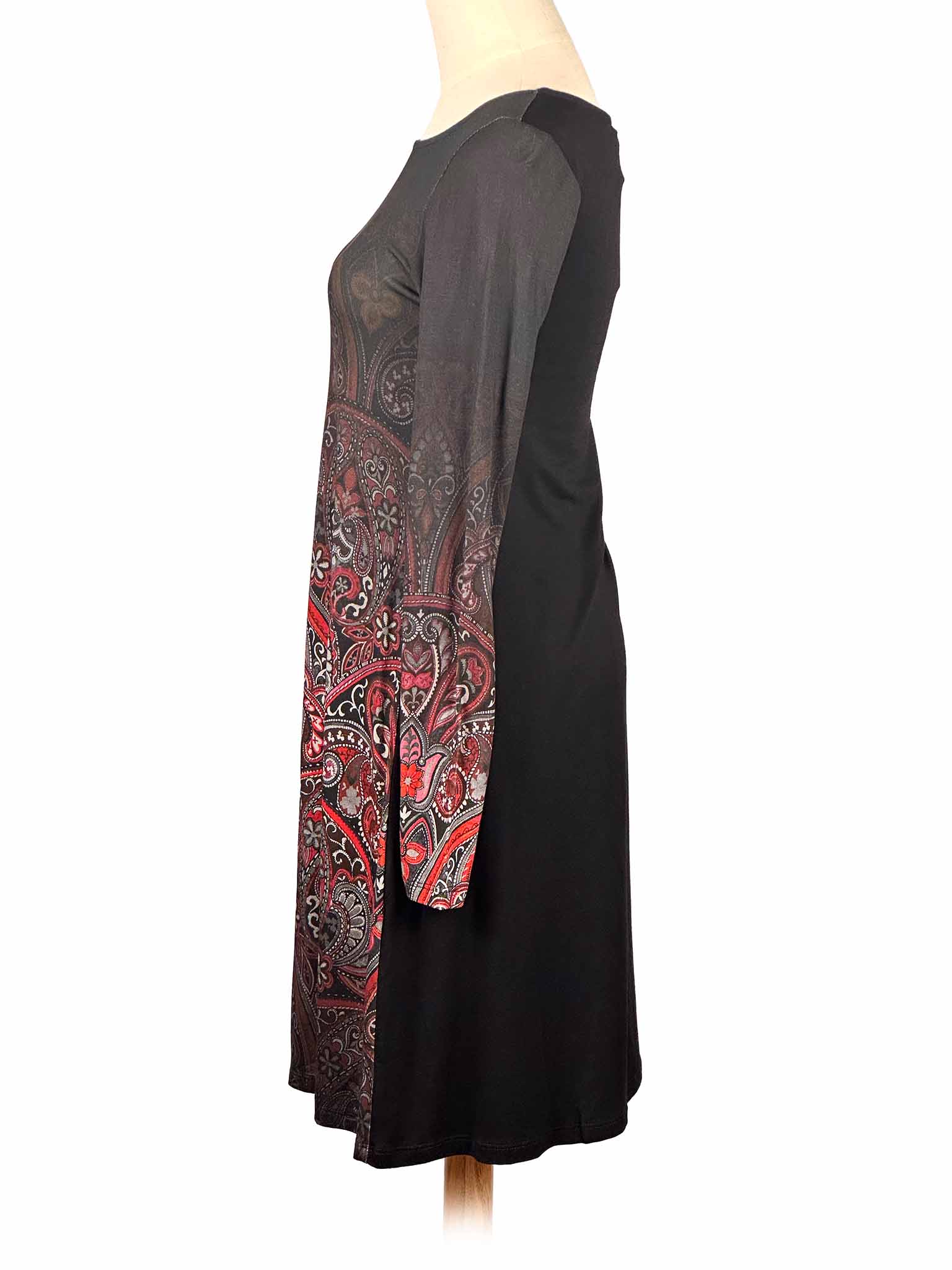 Long-sleeve Desigual dress with red and black paisley pattern on a mannequin against a white background