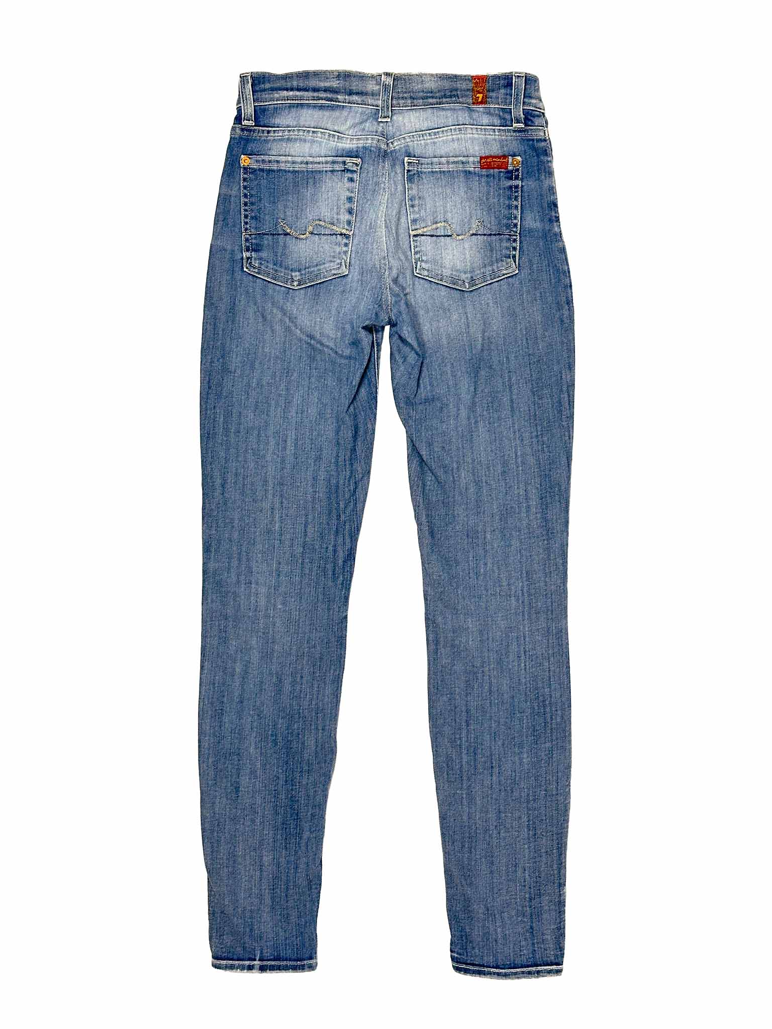 Pair of blue 7 For All Mankind jeans on a white background
